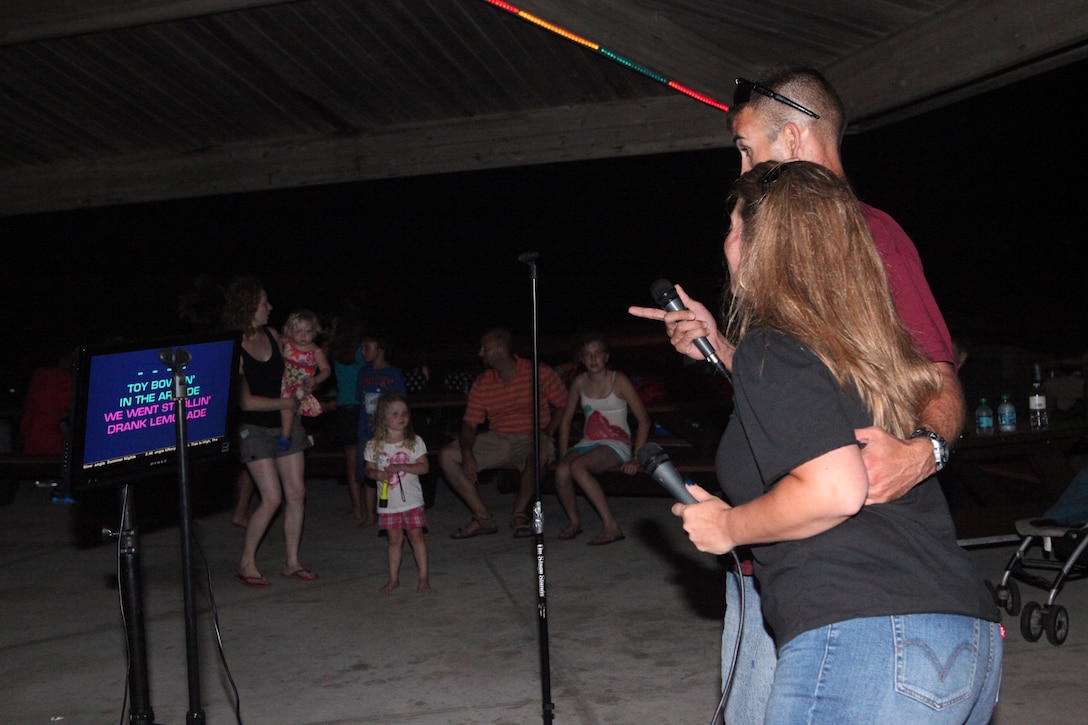 Chief Warrant Officer 2 Tevis Lang, the officer in charge with analysis method group, 2nd Intelligence Battalion, and his wife Angie sang karaoke during the Flashback Fridays classic rock-theme event hosted by Marine Corps Community Services at Onslow Beach aboard Marine Corps Base Camp Lejeune July 6. The disc jockey played classic rock from the 50s up to the 90s. 