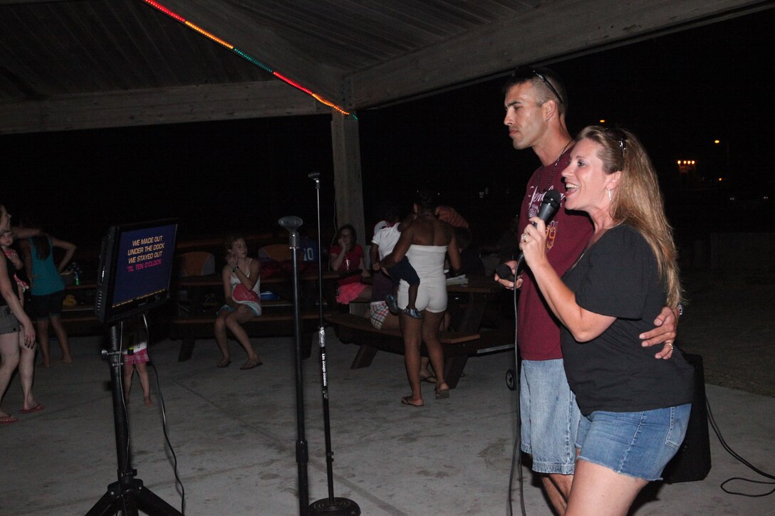 Chief Warrant Officer 2 Tevis Lang, the officer in charge with analysis method group, 2nd Intelligence Battalion, and his wife Angie sang karaoke during the Flashback Fridays classic rock-theme event hosted by Marine Corps Community Services at Onslow Beach aboard Marine Corps Base Camp Lejeune July 6. The disc jockey played classic rock from the 50s up to the 90s. 