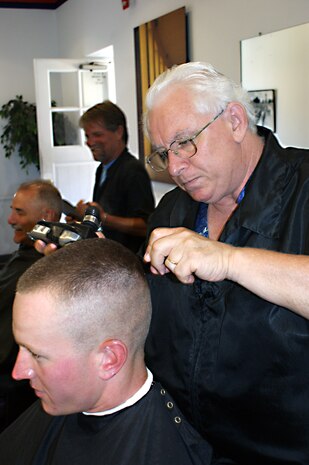 Riccardo 'Rick' Ferrantello, a fixture at the depot for the last year, Gives Pfc. Brandon Gigliotti, his first 'high and tight' as a Marine. Gigliotti was graduated from recruit training July 6, as a member of Platoon 3273, Company M, 3rd Recruit Training Battalion.