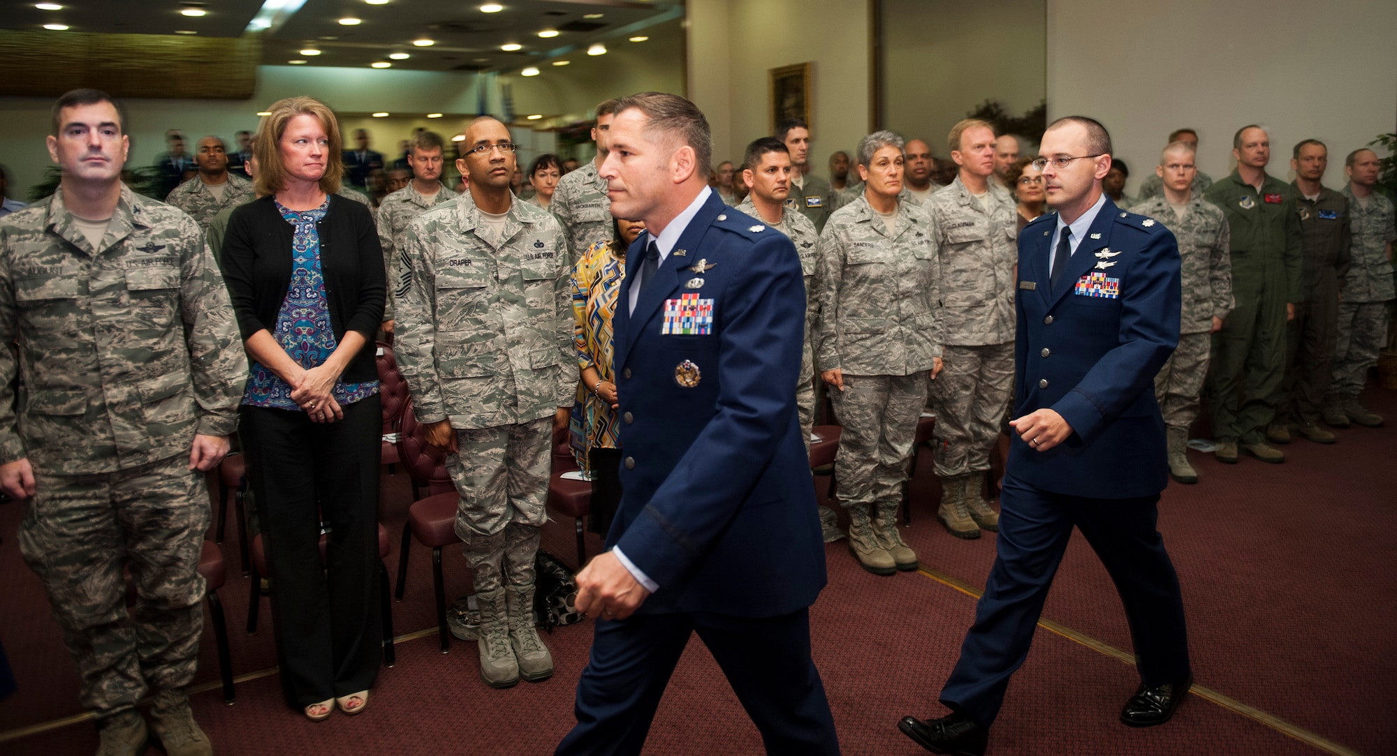 YOKOTA AIR BASE, Japan -- Lt. Col. Rocky Favorito, center, 374th Communications Squadron outgoing commander, walks into the Yokota Officers' Club Ballroom with his replacement, Lt. Col. Jon Autrey, at the start of the 374 CS change of command ceremony at Yokota Air Base, Japan, July 6, 2012. Favorito?s leadership was instrumental in his squadron earning the 2011 Air Force Information Dominance Maj. Gen. Harold M. McClelland (Large Unit) Award. (U.S. Air Force photo by Tech. Sgt. Samuel Morse)