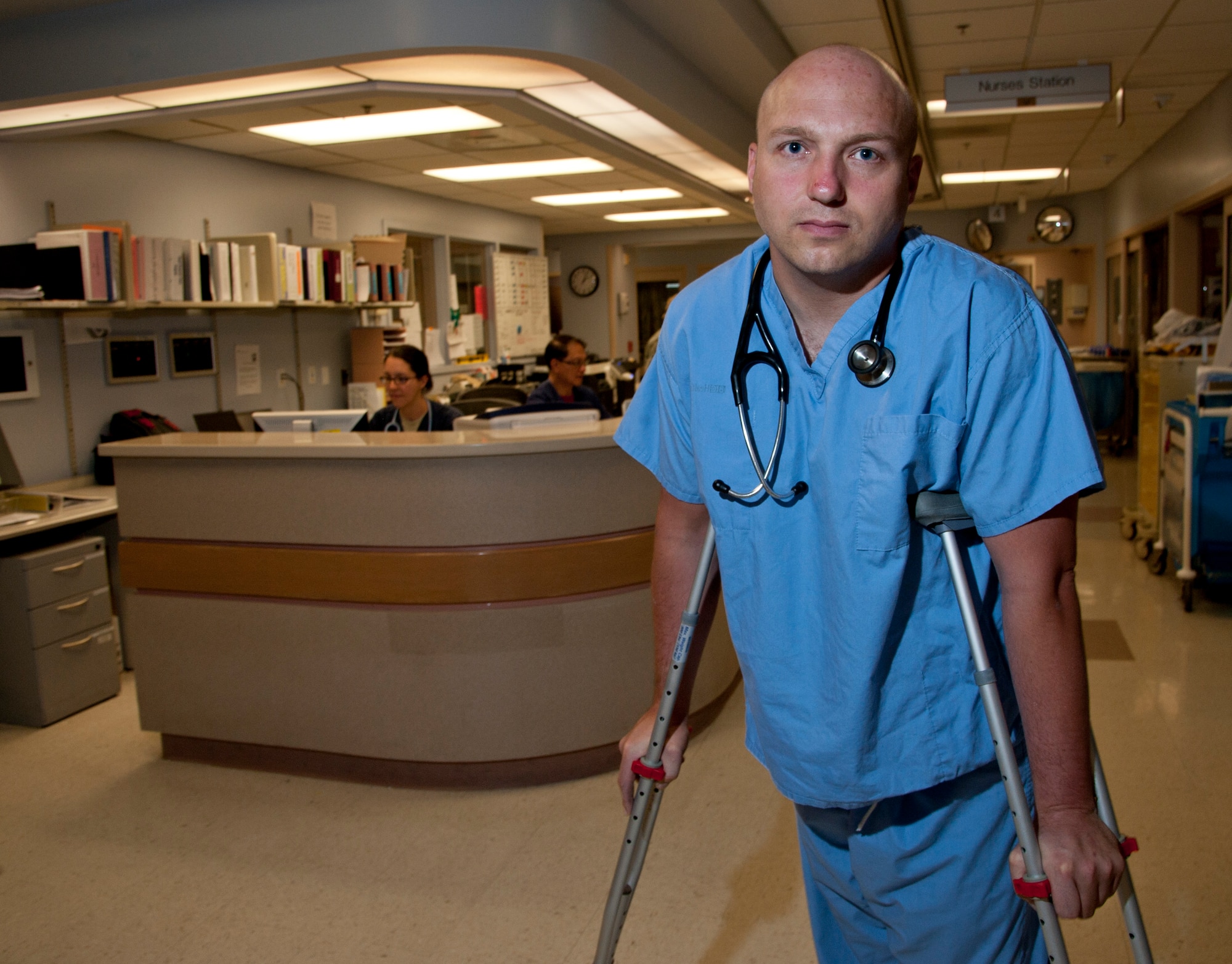 U.S. Air Force Maj. (Dr.) Jeremy Kilburn, 99th Medical Operations Squadron Cardio/Pulmonary Flight commander and Intensive Care Unit director, oversees operations in the Mike O'Callaghan Federal Medical Center's ICU July 10, 2012, at Nellis Air Force Base, Nev. Kilburn was a patient-turned-rescuer last week after breaking his leg in a hiking incident. In need of medical evacuation, Kilburn took action when a paramedic from the California Highway Patrol rescue helicopter was struck in the head by a rotor. (U.S. Air Force Photo by Master Sgt. Jason W. Edwards/released)
