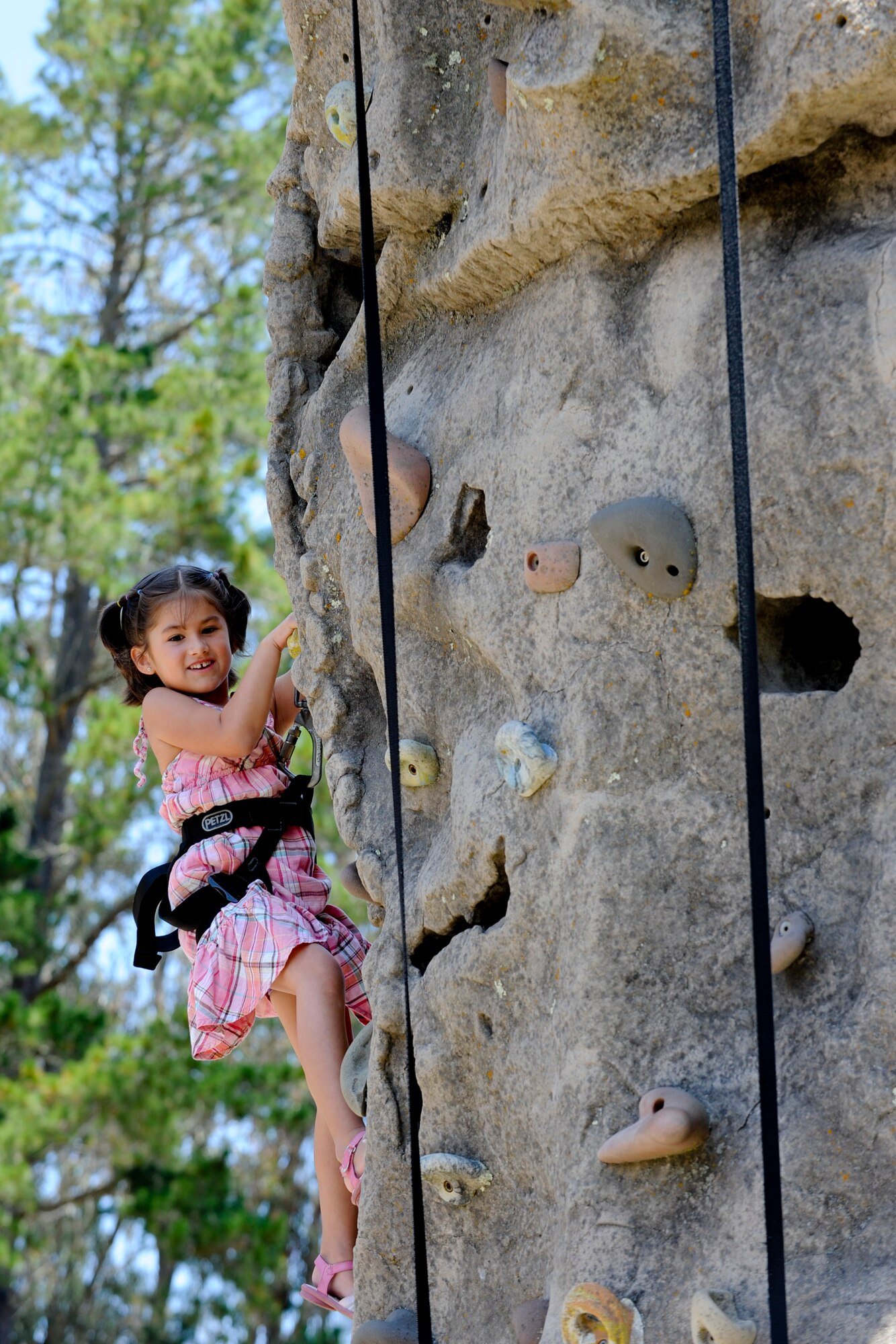 VANDENBERG AIR FORCE BASE, Calif. -- Layla Chavez, daughter of Nicole Chavez and Master Sgt. Ulysses Chavez, 614th Air Operations Center, climbs a rock wall during Vandenberg's Independence Day celebration here July 7, 2012.More than 1200 Team V members came to base to celebrate their nations independence. (U.S. Air Force photo/Staff Sgt. Levi Riendeau)
