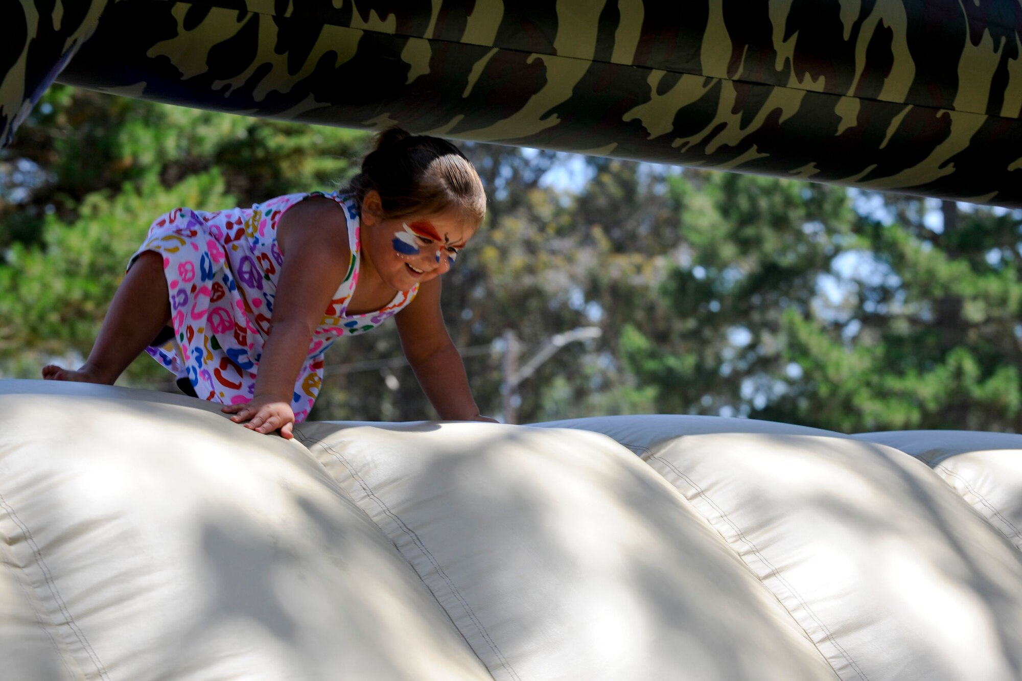 VANDENBERG AIR FORCE BASE, Calif. -- Jazlene Brady, daughter of Monica Brady and Tech. Sgt. Jason Brady, the 30th Security Forces Squadron noncommissioned officer in-charge of confinement,plays on an inflatable obstacle course during Vandenberg's Independence Day celebration here July 7, 2012. More than 1200 Team V members came to base to celebrate their nations independence. (U.S. Air Force photo/Staff Sgt. Levi Riendeau)
