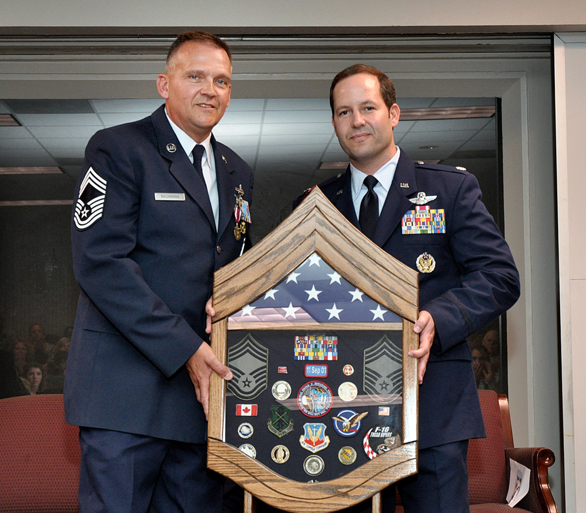 Lt Col Jon Stone presented a shadow box to Chief Master Sergeant Randy Bachmann, Detachment 1, Chief Enlisted Manager, in honor of his 26 year Air Force career at a retirement ceremony held 28 June 2012, at Ellington Field, Houston Texas.  CMSgt Bachmann served 20 of his 26 years at alert detachments. 