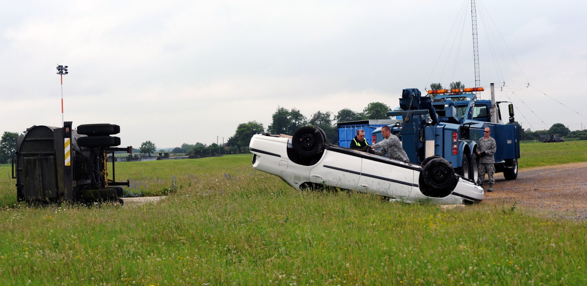 RAF MILDENHALL, England -- The 442nd Logistics Readiness Squadron vehicle operators recover a rolled-oved vehicle during an exercise, July 5, 2012. The operators, along with approximately 50 other reservists from the squadron, were deployed here for training. The 442nd LRS is part of the 442nd Fighter Wing, an A-10 Thunderbolt II Air Force Reserve unit at Whiteman Air Force Base, Mo. (U.S. Air Force photo/Staff Sgt. Danielle Johnston)