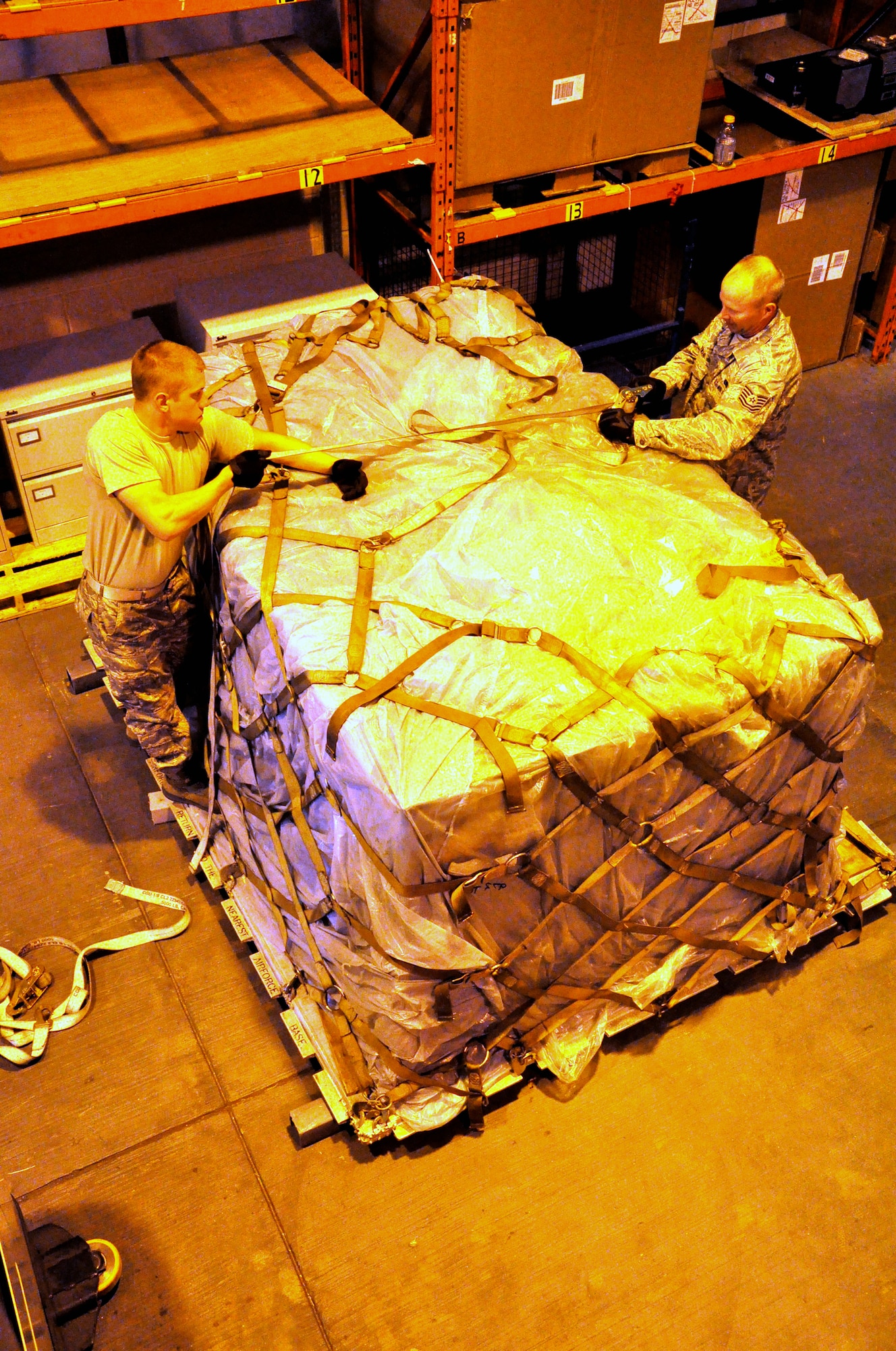RAF MILDENHALL, England -- Airman 1st Class Jeremy Blaszczyk and TSgt Shawn Lindeman, 442nd Logistics Readiness Squadron supply technicians, build a pallet, July 2, 2012. Blaszczyk and Lindeman, along with approximately 50 other reservists from the squadron, were deployed here for training. The 442nd LRS is part of the 442nd Fighter Wing, an A-10 Thunderbolt II Air Force Reserve unit at Whiteman Air Force Base, Mo. (U.S. Air Force photo/Staff Sgt. Danielle Johnston)