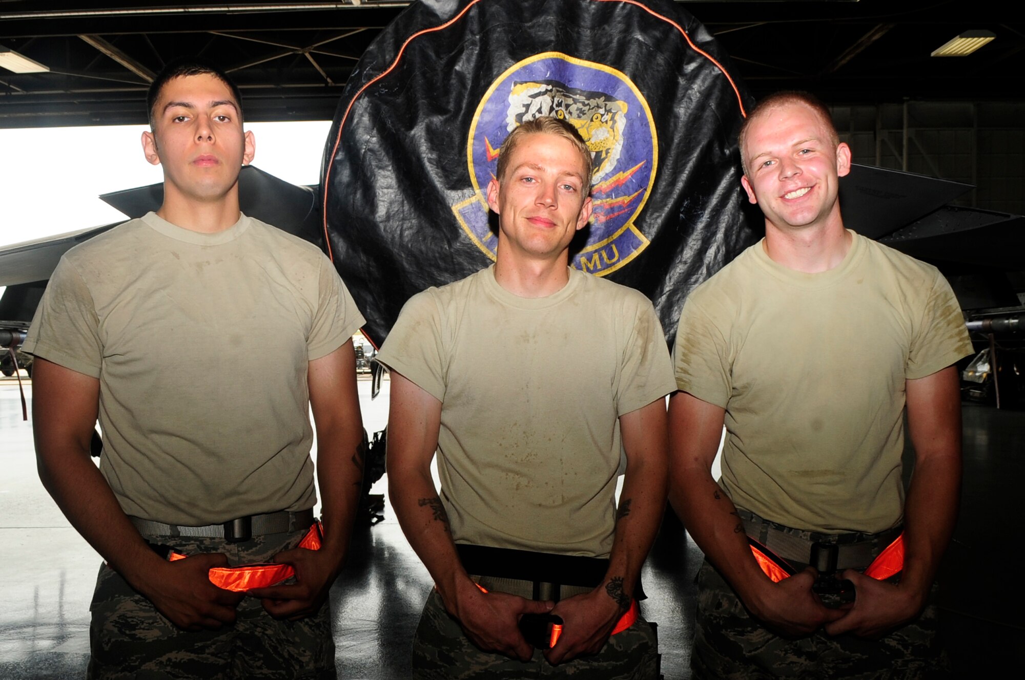 U.S. Air Force Senior Airman Gilberto Garza (left), Staff Sgt. Rex Renfro and Senior Airman Robert Olsen, 20th Aircraft Maintenance Squadron pose for a photo after winning a quarterly load crew competition at Shaw Air Force Base, S.C., July 6, 2012. Load crew competitions are held once a quarter, testing the speed and precision of each load crew participant. (U.S. Air Force photo by Airman 1st Class Hunter Brady/Released)