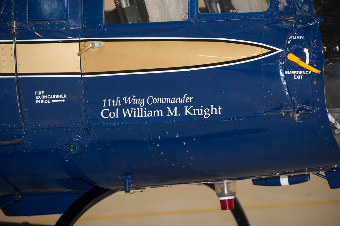 The name of Col. Bill M. Knight, newly-seated 11th Wing/Joint Base Andrews commander, is unveiled on a UH-1N Huey helicopter during the 11th Wing Change of Command ceremony held in Hangar 3 here July 6. (Photo/Bobby Jones)