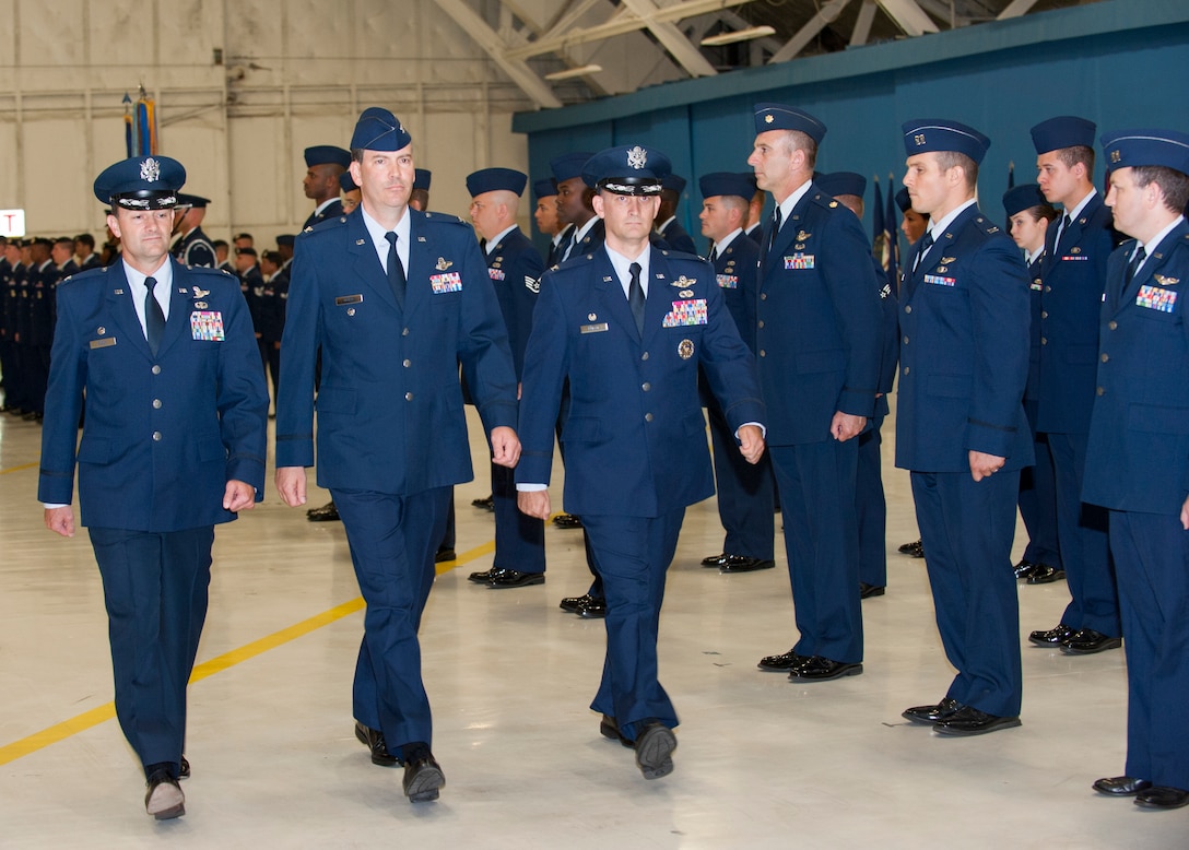 Col. Ken Rizer, 11th Wing/Joint Base Andrews commander, left, Col. Greg N. Urtso, 11th Wing/Joint Base Andrews vice commander, and Col. Bill M. Knight, right, assuming 11th Wing/Joint Base Andrews commander, perform a pass in review of 11th Wing members during the wing’s Change of Command ceremony held in Hangar 3 here July 6. (Photo/Bobby Jones)