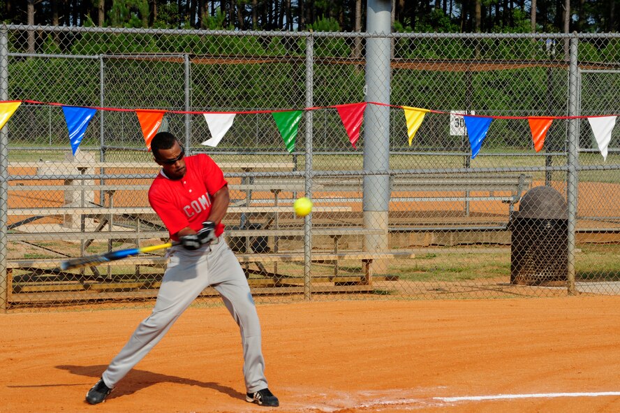 Senior Airman Joshua Loatman, 20th Communications Squadron cyber transport technician, swings at the incoming ball during a softball game at Shaw Air Force Base’s sports complex, S.C., July 9, 2012. Shaw provides many recreational and intramural sport opportunities for Airmen to participate in throughout the year. (U.S. Air Force photo by Airman 1st Class Daniel Blackwell/Released)