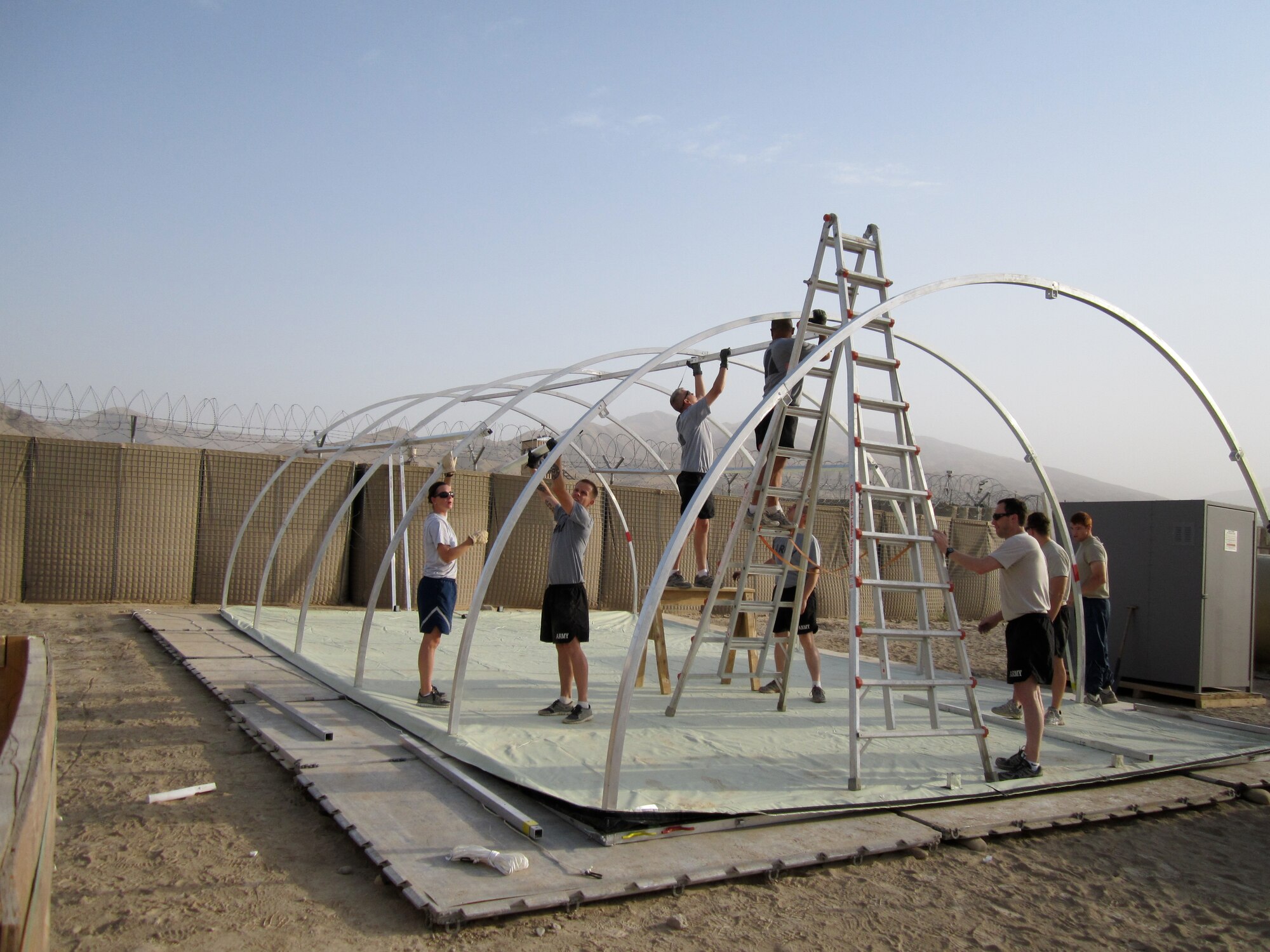 Airmen from the 2nd Forward Surgical Team set up one of the tents they will be sleeping in for the duration of the deployment in Combat Outpost Khilagay, Afghanistan, July 8, 2011. They saw over 350 trauma patients and preformed approximately 90 medical evacuations. Their patients included victims from gun shots, improvised explosive device blasts, and suicide bombers. (Courtesy photo)
