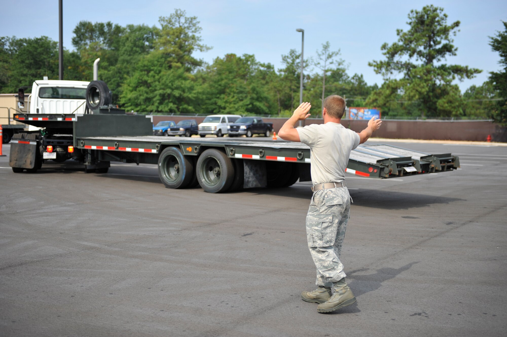 U.S. Air Force Senior Airman Stewart Crotts directs his teammate Airman 1st Class Zachary Lakatos, both 20th Logistics Readiness Squadron vehicle operators, through an obstacle course during the first-ever quarterly vehicle rodeo competition at Shaw Air Force Base, S.C., July 6, 2012. The vehicle rodeo was a competition amongst LRS Airmen meant to prepare them for unique mission challenges and build teamwork and communication skills. (U.S. Air Force photo by Senior Airman Amber E. N. Jacobs/Released)