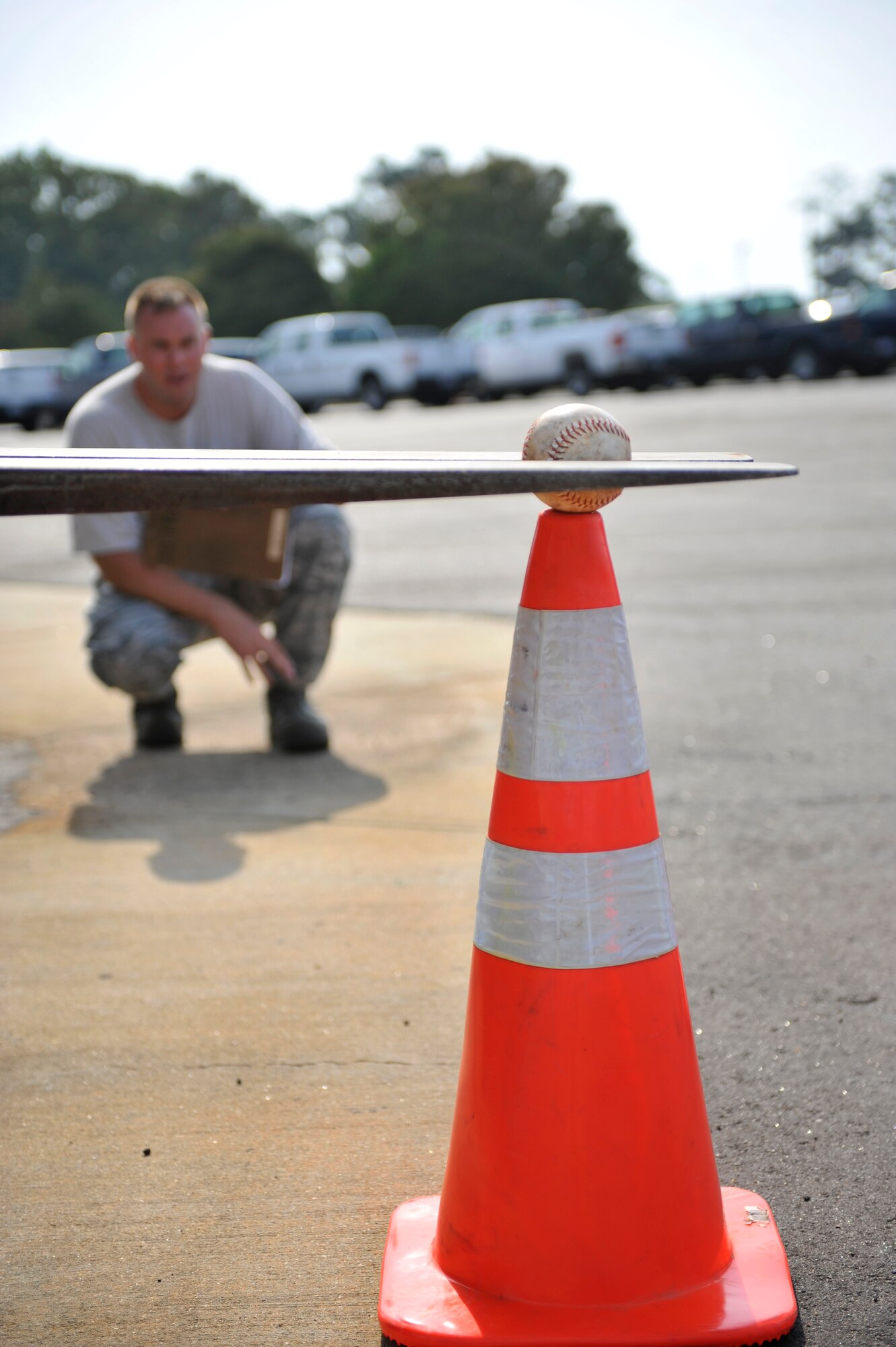 U.S. Air Force Tech. Sgt. Anthony Maikkula, 20th Logistics Readiness Squadron NCOIC of equipment support, watches as a softball is being lowered on to a traffic cone by a 10K standard forklift during the first-ever quarterly vehicle rodeo competition at Shaw Air Force Base, S.C., July 6, 2012. The forklift event required competitors to pick-up a softball only using the forks of the vehicle, maneuver it backwards through an obstacle course, and place the ball onto a traffic cone while relying on their spotters to direct them. (U.S. Air Force photo by Senior Airman Amber E. N. Jacobs/Released)