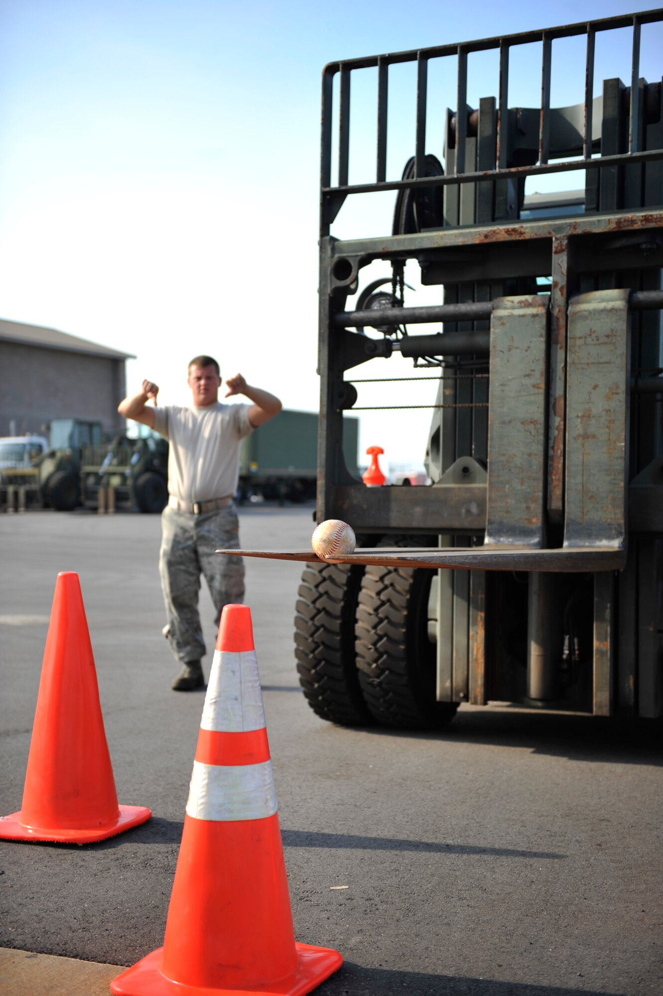 U.S. Air Force Senior Airman Stewart Crotts directs his teammate Airman 1st Class Zachary Lakatos, both 20th Logistics Readiness Squadron vehicle operators, to lower the forks of a 10K standard forklift during the first-ever quarterly vehicle rodeo competition at Shaw Air Force Base, S.C., July 6, 2012. The vehicle rodeo was a competition amongst LRS Airmen meant to strengthen maneuvering and communication skills. (U.S. Air Force photo by Senior Airman Amber E. N. Jacobs/Released)