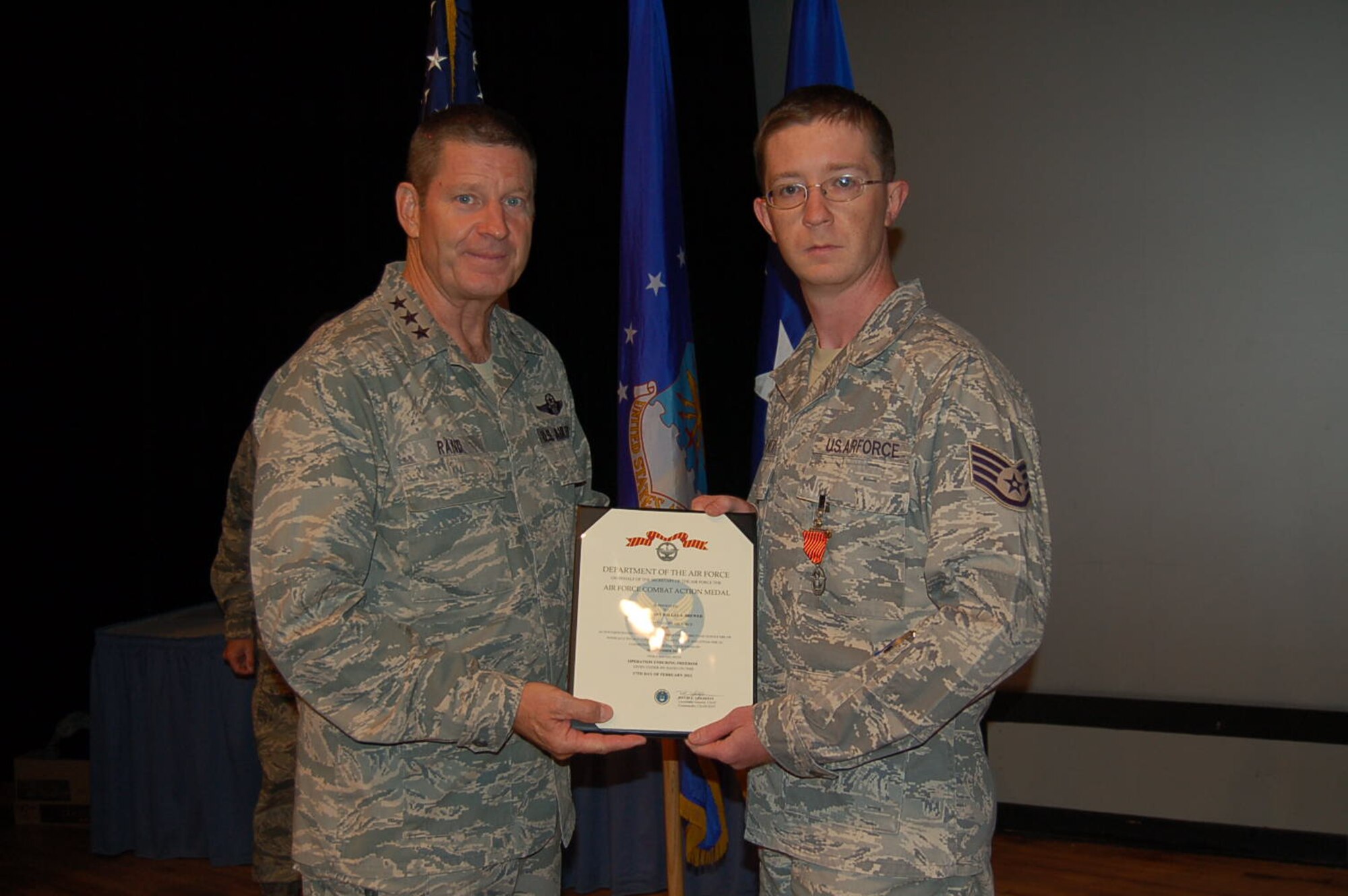 Lt. Gen. Robin Rand, 12th Air Force (Air Forces Southern) commander presents Staff Sgt. Dallas Brewer, 12th AF (AFSOUTH) Judge Advocate office, with the Air Force Combat Action Medal here, June 19, 2012, for combat actions while deployed to Afghanistan. (U.S. Air Force photo byMaster Sgt. Kelly Ogden)