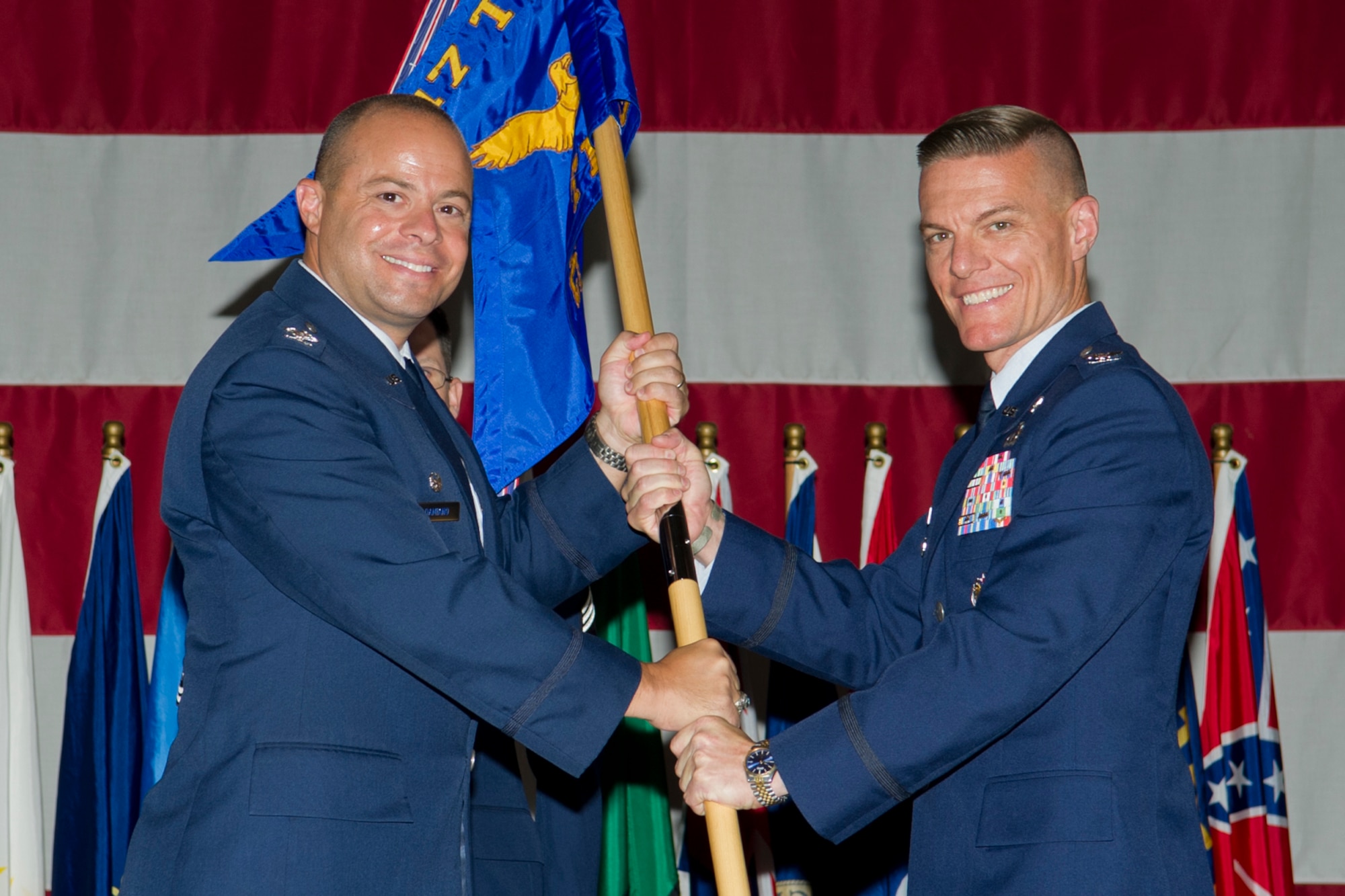 GOODFELLOW AIR FORCE BASE, Texas - Col. Mark Damiano, 17th Training Wing commander, passes the 17th Training Group guidon to Col. Brendan Harris, during a change of command ceremony July 10. Harris assumed command of the 17th TRG from Col. JD Willis. (U.S. Air Force photo/Staff Sgt. Laura R. McFarlane)  