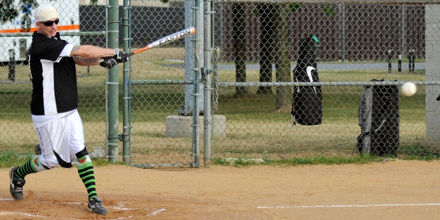 Morgan Bell, pitcher with the 436th Civil Engineers Squadron A team, blasts a triple against the 436th Communications Squadron in American League softball action July 9, 2012, at Dover Air Force Base, Del. Bell went 3-for-4 with a triple, a double and five RBIs as the 436th CES A won 18-2. (U.S. Air Force photo by Tech. Sgt. Chuck Walker)