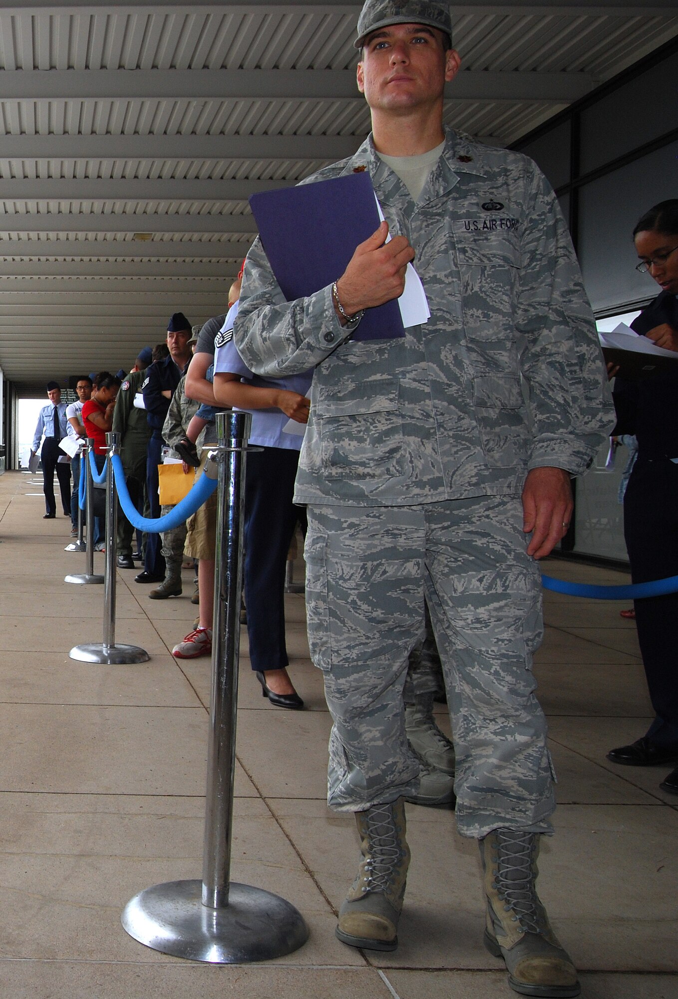 Air Force Academy housing residents wait in line to file vouchers at the Academy Community Center July 9, 2012. Approximately 50 Airmen and civilian employees from the Academy and other local military installations set up a processing line to streamline the voucher application process. (U.S. Air Force photo/Don Branum)