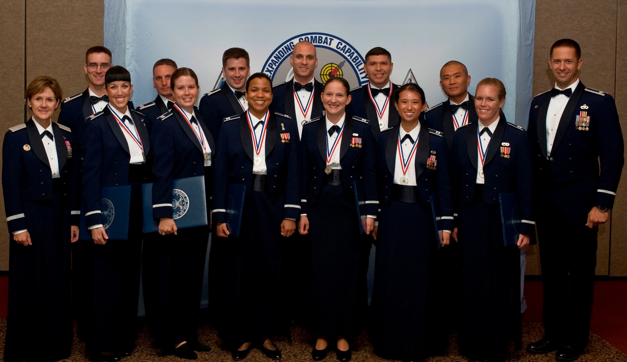 U.S. Air Force Advanced Maintenance and Munitions Officer School Combat Support Course class 12A graduates pose for a group photo after receiving their diplomas, June 22, 2012, at Nellis Air Force Base, Nev. The 15-week course conducts the most advanced and comprehensive training of expeditionary combat support processes to develop highly skilled professionals capable of integrating all facets of Agile Combat Support anywhere in the world. (U.S. Air Force photo by Airman 1st Class Daniel Hughes) 