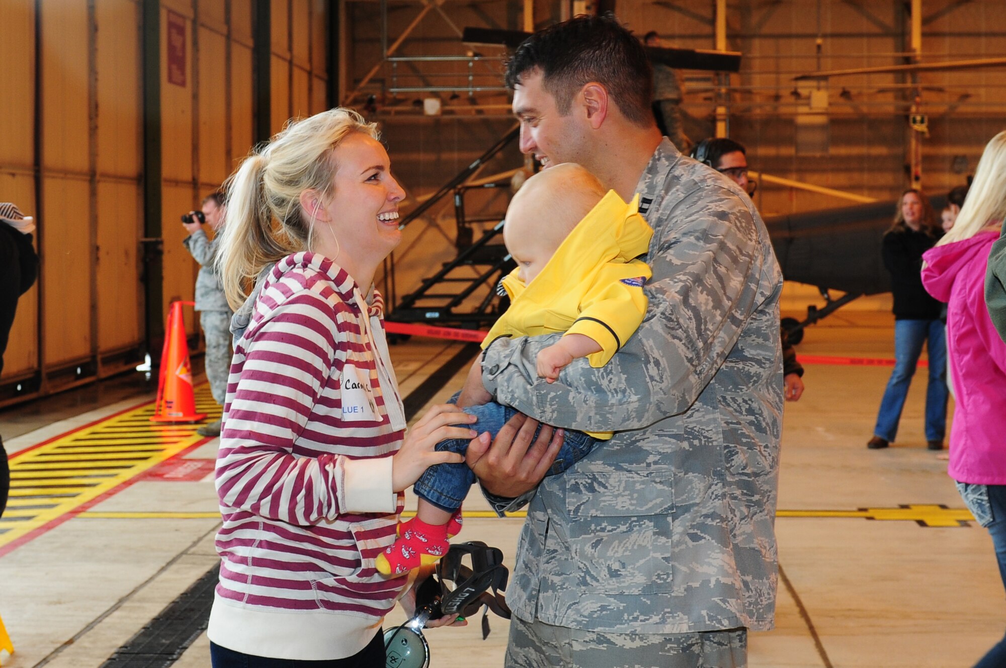 ROYAL AIR FORCE LAKENHEATH, England – Carmel Chase greets her husband Capt. William Chase, 56th Rescue Squadron flight commander, and their son Ethan after a spouses’ incentive flight on an HH-60G Pave Hawk July 6, 2012. The 56th RQS hosted a day at the squadron featuring incentive flights for more than 50 family members as well as jumping castles and coloring activities for children. (U.S. Air Force photo by Airman 1st Class Cory D. Payne)