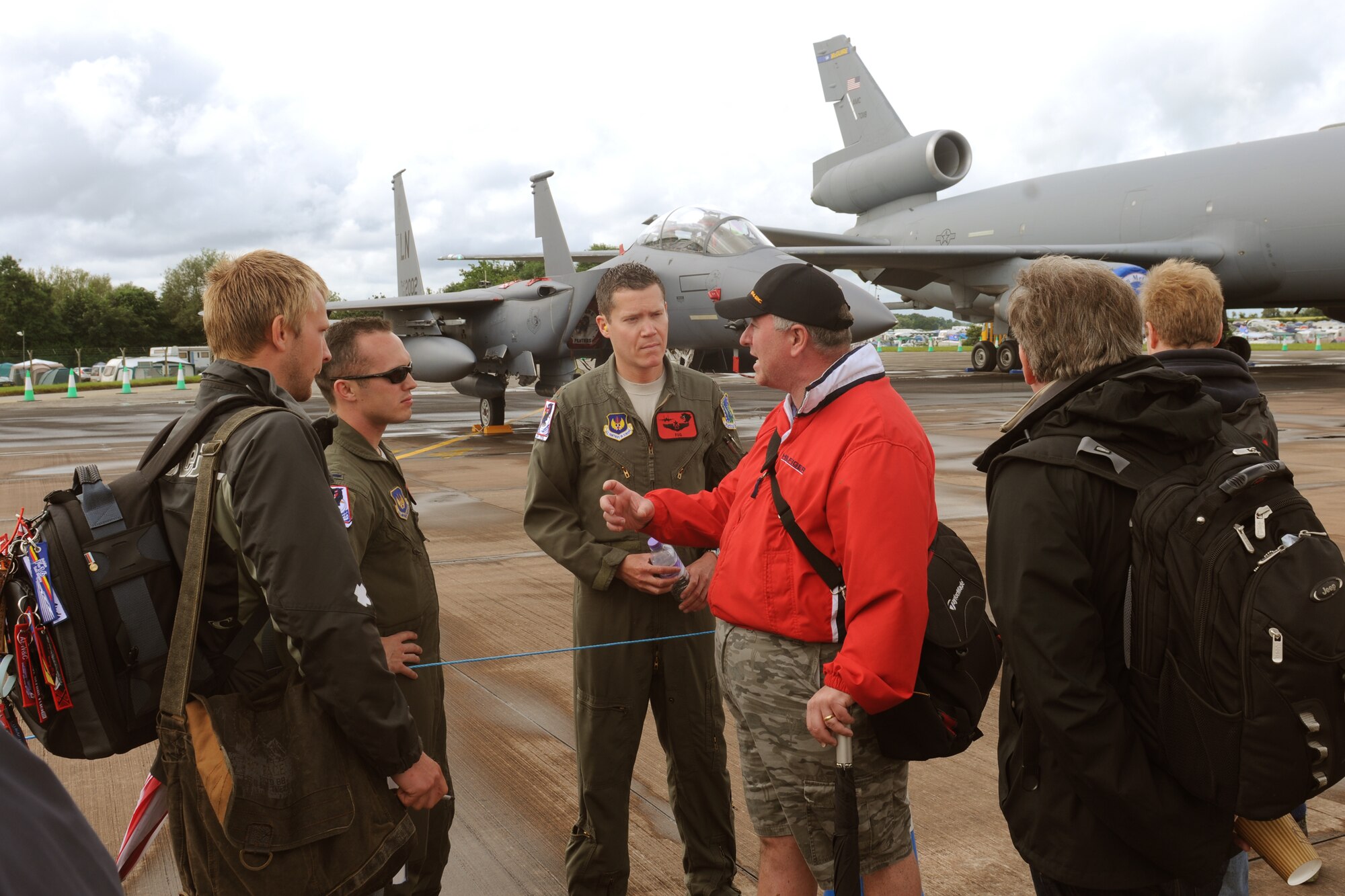 RAF FAIRFORD, United Kingdom - Ian Warner, of Sharnford, Leicestershire, talks with Maj. Jon Lee and 1st Lt. Adam Thompson, 494th Fighter Squadron, about squadron patches during the Royal International Air Tattoo at RAF Fairford. Lee and Thompson flew an F-15E Strike Eagle from RAF Lakenheath to display during RIAT. (U.S. Air Force photo by Capt. Brian Maguire)