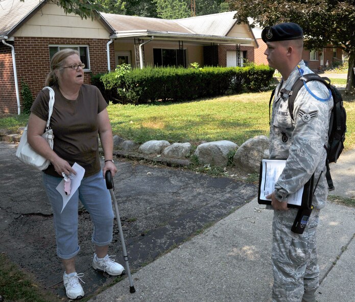 Senior Airman Jeremiah Taylor, 178th Security Forces Squadron, checks on the health and welfare of a Montgomery County, Ohio resident June 2, 2012 in response to recent storm damages. The storm left thousands without power and Ohio Governor John Kasich declared a state of emergency calling upon the Ohio Air and Army National Guard to assist those in need.