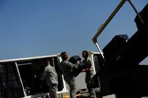Members of the 728th Air Mobility Squadron load luggage onto a World Air MD-11 passenger airplane July 10, 2012, at Incirlik Air Base, Turkey. The 728th AMS is a tenant unit to the 39th Air Base Wing and consists of approximately 300 permanent-party Airmen, deployed Airmen and Turkish nationals, as well as an additional 50 Airmen at Transit Center at Manas, Kyrgyzstan. (U.S. Air Force photo by Senior Airman Jarvie Z. Wallace/Released)
