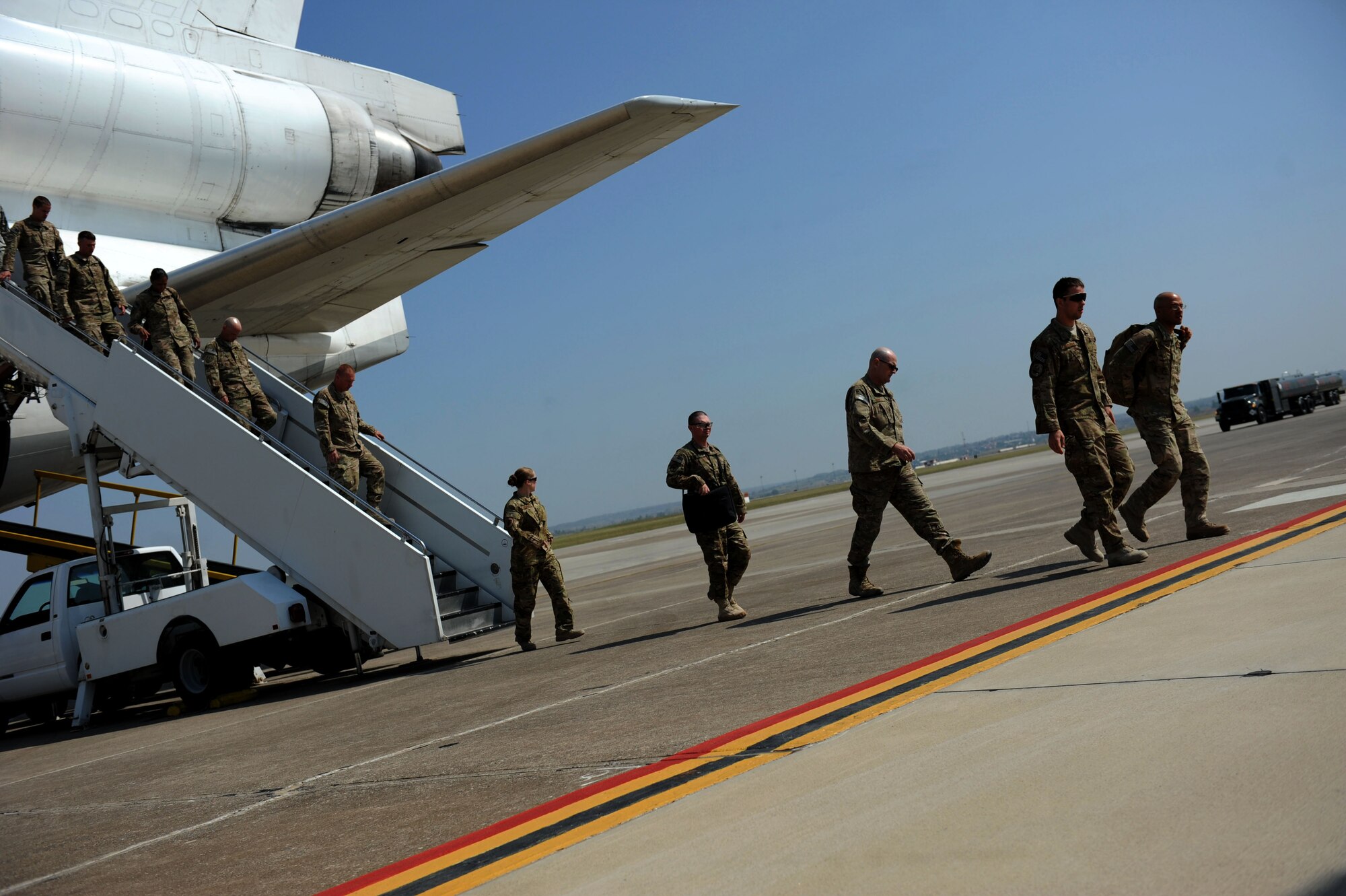 U.S. service members exit a World Air MD-11 passenger airplane July 10, 2012, at Incirlik Air Base, Turkey. The 728th Air Mobility Squadron operates the passenger terminal and is at the front line of efforts to deliver service members and lifesaving cargo to several key locations across Eastern Europe, Southwest and Central Asia, and parts of Northern Africa. (U.S. Air Force photo by Senior Airman Jarvie Z. Wallace/Released) 
