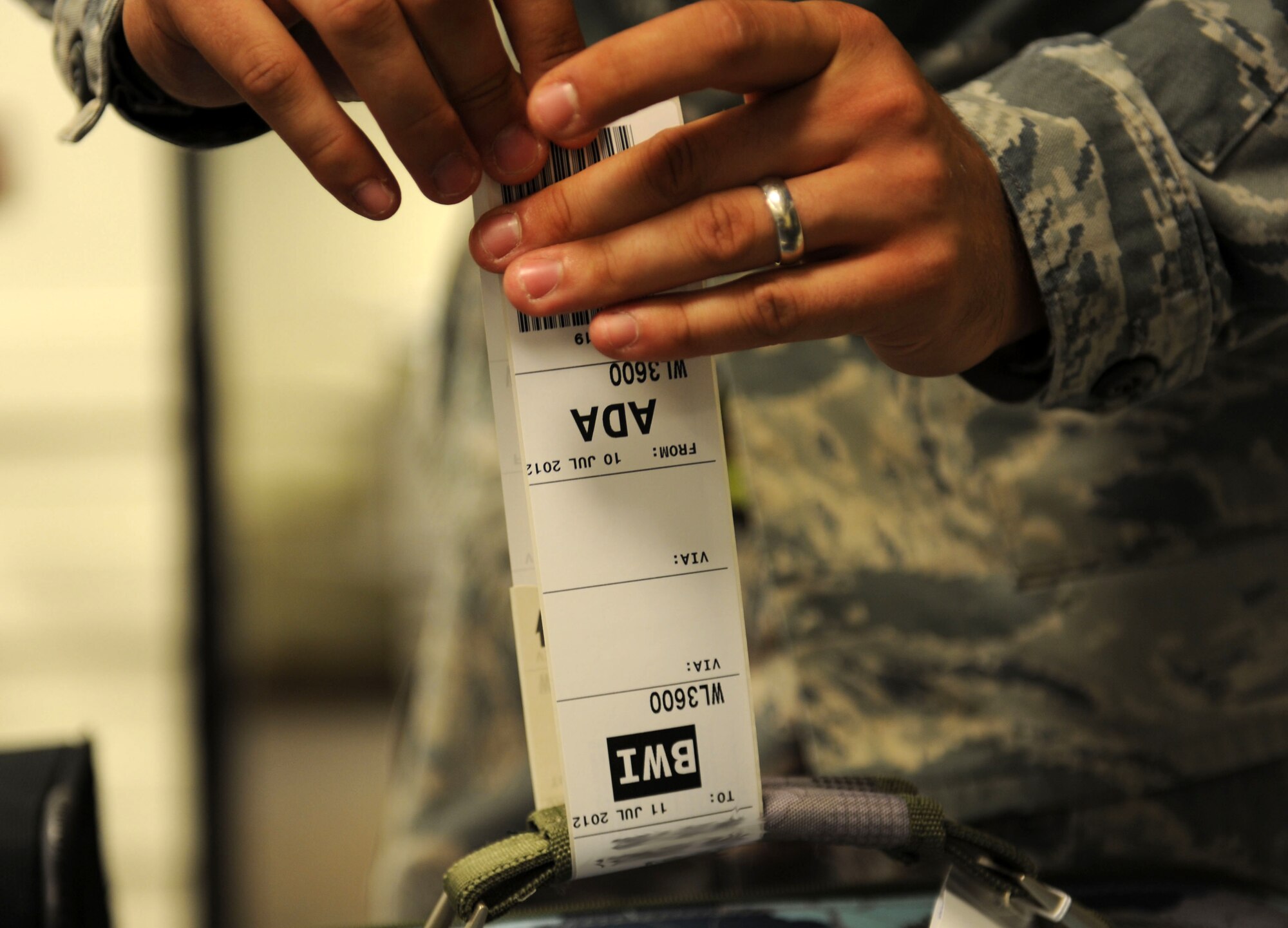 Senior Airman Joshua McGee, 728th Air Mobility Squadron passenger service agent, tags luggage at the Incirlik passenger terminal July 10, 2012, at Incirlik Air Base, Turkey. The 728th AMS is a tenant unit to the 39th Air Base Wing and consists of approximately 300 permanent-party Airmen, deployed Airmen and Turkish nationals, as well as an additional 50 Airmen at Transit Center at Manas, Kyrgyzstan. (U.S. Air Force photo by Senior Airman Jarvie Z. Wallace/Released)