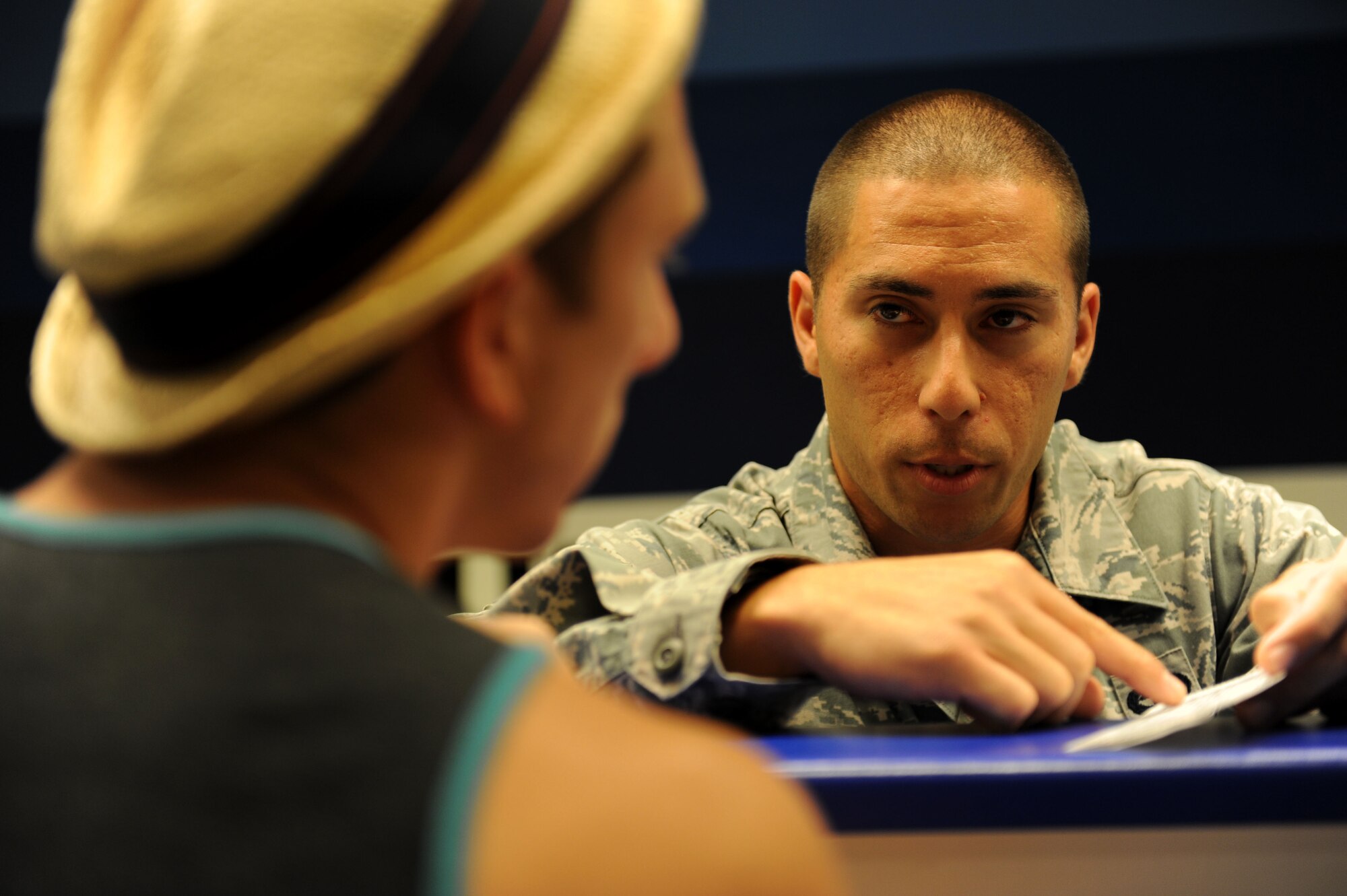 Staff Sgt. Gregory Viruet, 728th Air Mobility Squadron passenger service supervisor, discusses flight information with a passenger at the Incirlik passenger terminal July 10, 2012, at Incirlik Air Base, Turkey. The 728th AMS is a tenant unit to the 39th Air Base Wing and consists of approximately 300 permanent-party Airmen, deployed Airmen and Turkish nationals, as well as an additional 50 Airmen at the Transit Center at Manas, Kyrgyzstan. (U.S. Air Force photo by Senior Airman Jarvie Z. Wallace/Released)