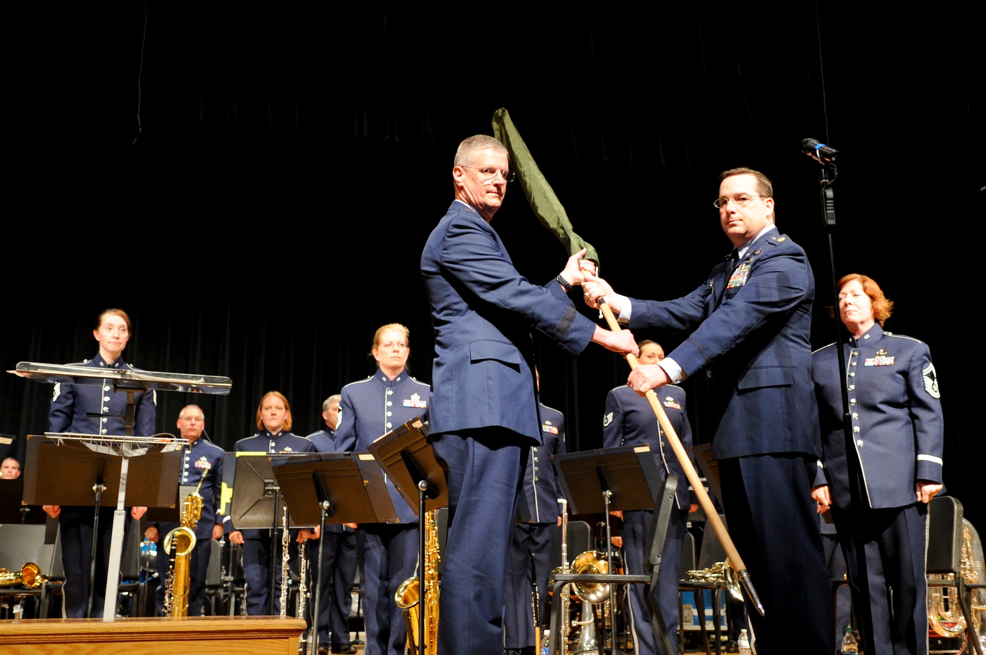 Maj. Matthew Zelnik, commander of the 555th Air Force Band relinquishes command of the band to The Ohio National Guard Assistant Adjutant General for Air, Brig. Gen. Mark Bartman, during a deactivation ceremony at Anthony Wayne High School in Whitehouse, Ohio July 7, 2012. The band, commonly called The Triple Nickel, performed for the final time during the deactivation ceremony. Dating back to 1923, the band is scheduled to be officially deactivated in 2013 after nearly a century of service as part of the Ohio Air National Guard. (U.S. Air Force photo by Master Sgt. Beth Holliker/Released)