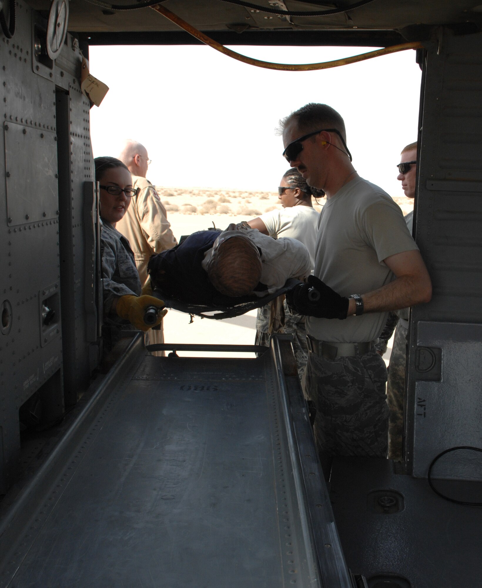 SOUTHWEST ASIA – Airmen from the 386th Expeditionary Medical Group learn how to properly remove casualty from a helicopter safely here July 2. The U.S. Army Aviation Unit, General Support Aviation Battalion, gave them the opportunity to train and exercise for real-world scenarios. (U.S. Air Force photo/Staff Sgt. Alexandra M. Boutte)