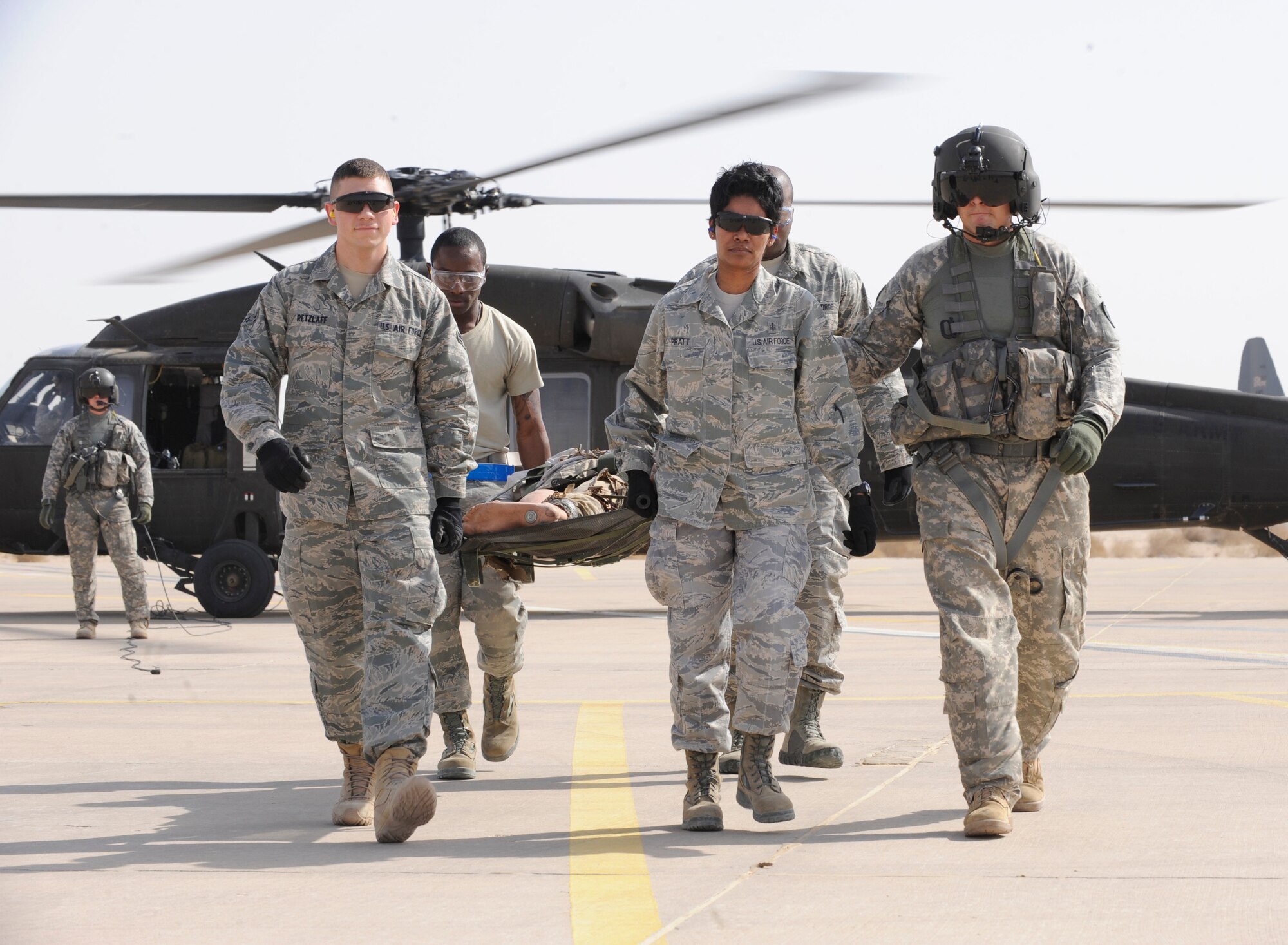 SOUTHWEST ASIA – U.S. Army Staff Sgt. Zack Kazaan, 1-126th Aviation Unit, General Support Aviation Battalion medic, right, instructs 386th Expeditionary Medical Group litter crewmembers on proper loading procedures to get a “casualty” evacuated to a hospital during a medical evacuation exercise here July 2. The exercise tested the response capabilities of medics in a joint Army and Air Force effort. (U.S. Air Force photo/Staff Sgt. Alexandra M. Boutte)