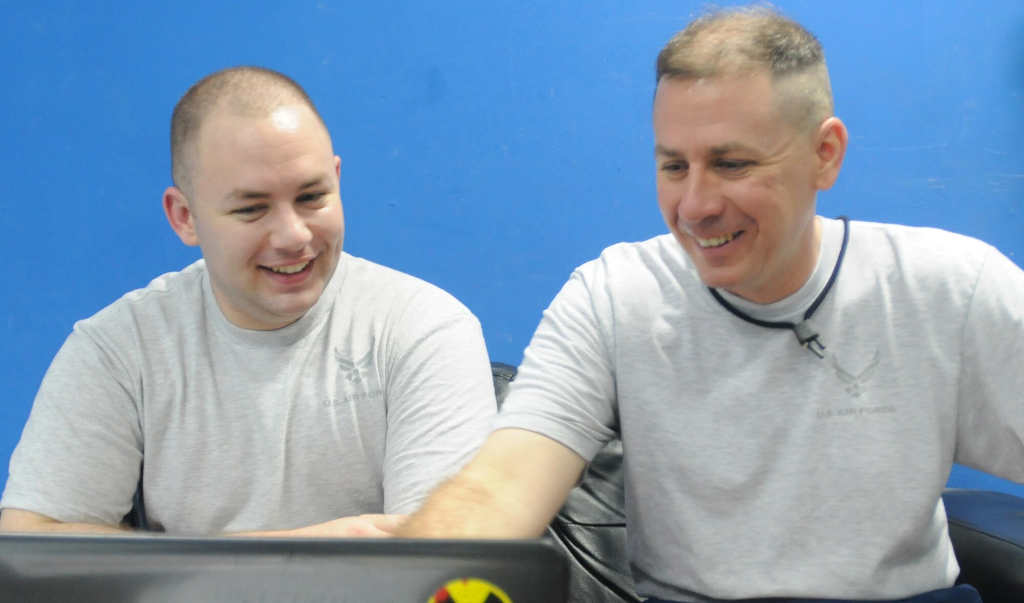 SOUTHWEST ASIA - U.S. Air Force Senior Airman Michael Ford, 970th Expeditionary Airborne Air Control Squadron computer display maintenance technician, and his father, Chief Master Sgt. William Ford, 380th Expeditionary Operations Group superintendent, watch videos on a computer together July 7, 2012. Michael is deployed from Tinker Air Force Base, Okla., and William is deployed from Offutt AFB, Neb. (U.S. Air Force photo/Tech. Sgt. Amanda Savannah)