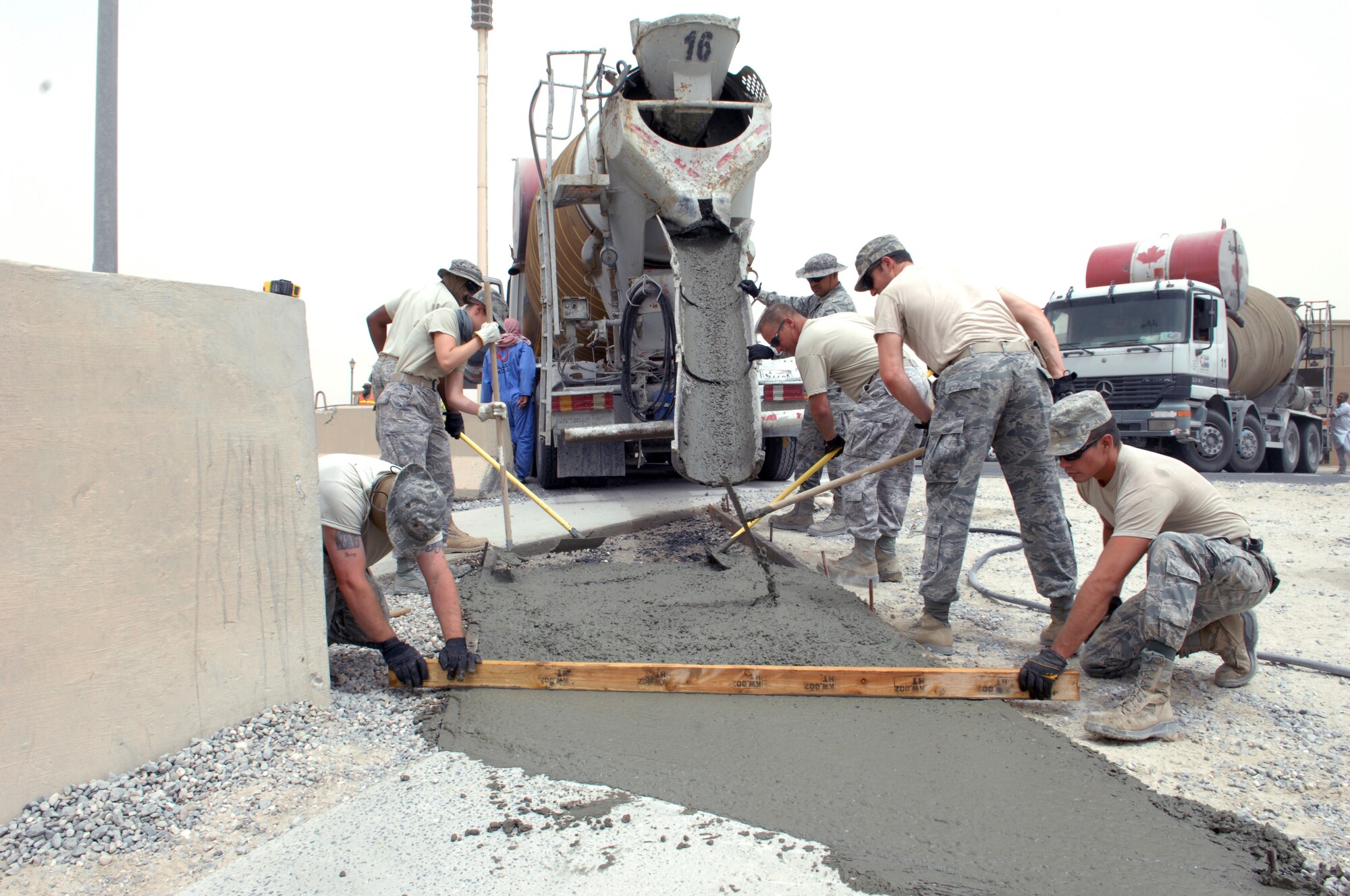 SOUTHWEST ASIA – Members of the 386th Expeditionary Civil Engineer Squadron, work to connect two sidewalks into one at the dining facility here July 7. The members also widened the sidewalk from the exit door of the facility. (U.S. Air Force photo/Staff Sgt. Alexandra M. Boutte) 