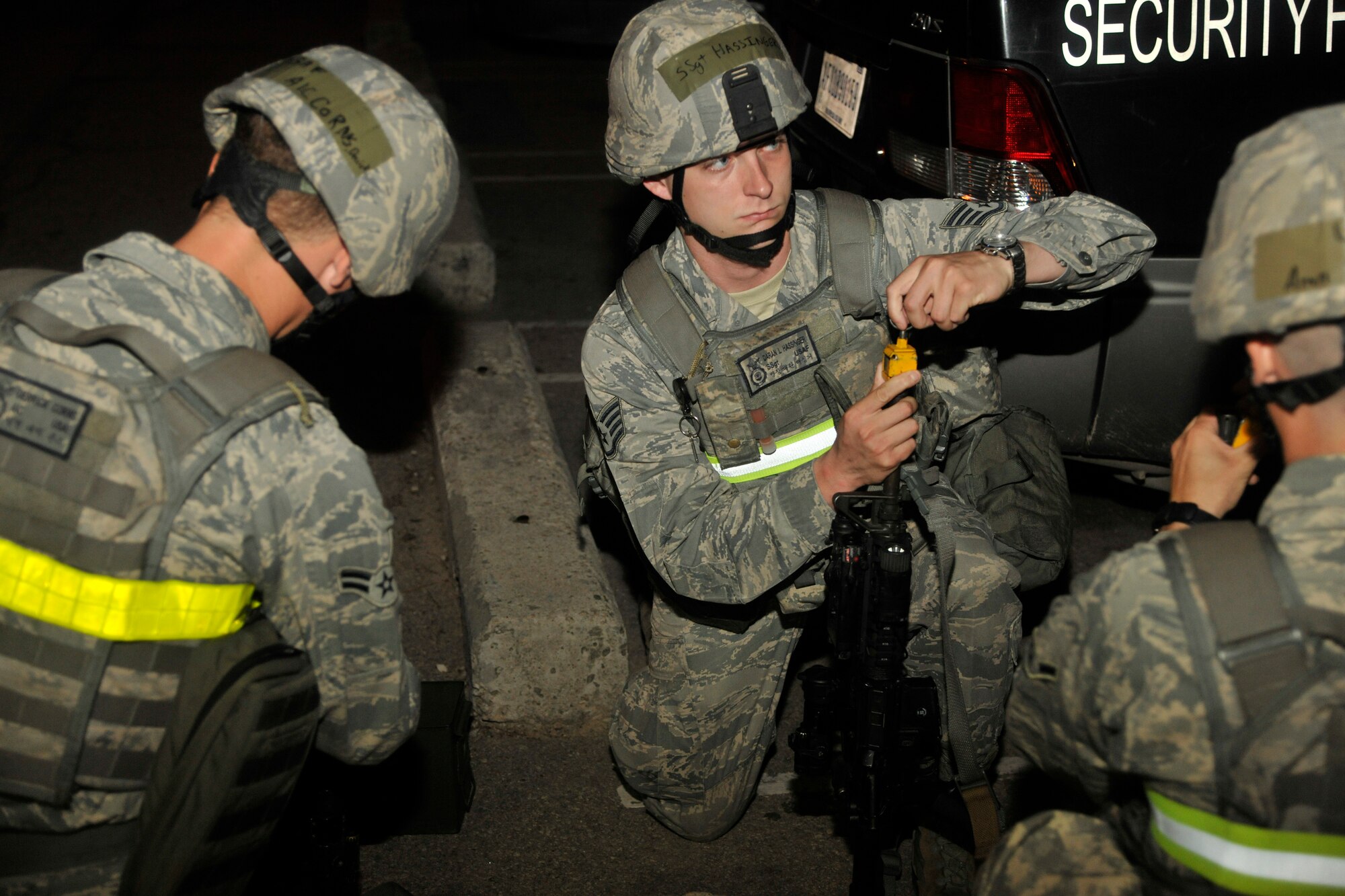 Airmen from the 8th Security Forces Squadron place a blank-firing adaptor over the muzzle of their weapons during an exercise at Kunsan Air Base, Republic of Korea, July 8, 2012. The adaptor allows the weapon to function properly and safely while using blank rounds for training and exercise purposes. (US Air Force photo/Senior Airman Marcus Morris)