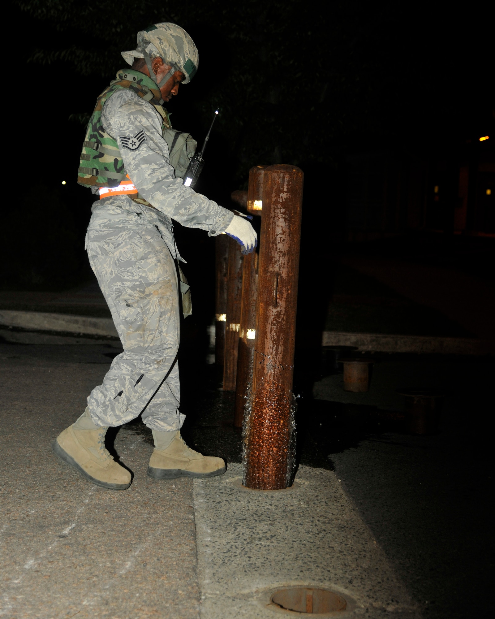 Staff Sgt. Mardie Wilson, 8th Civil Engineer Squadron heavy equipment and pavement, blockades the roads at Kunsan Air Base, Republic of Korea, July 8, 2012. The blockades are used to stop access into some areas of the base during the exercise. (US Air Force photo/Senior Airman Marcus Morris)