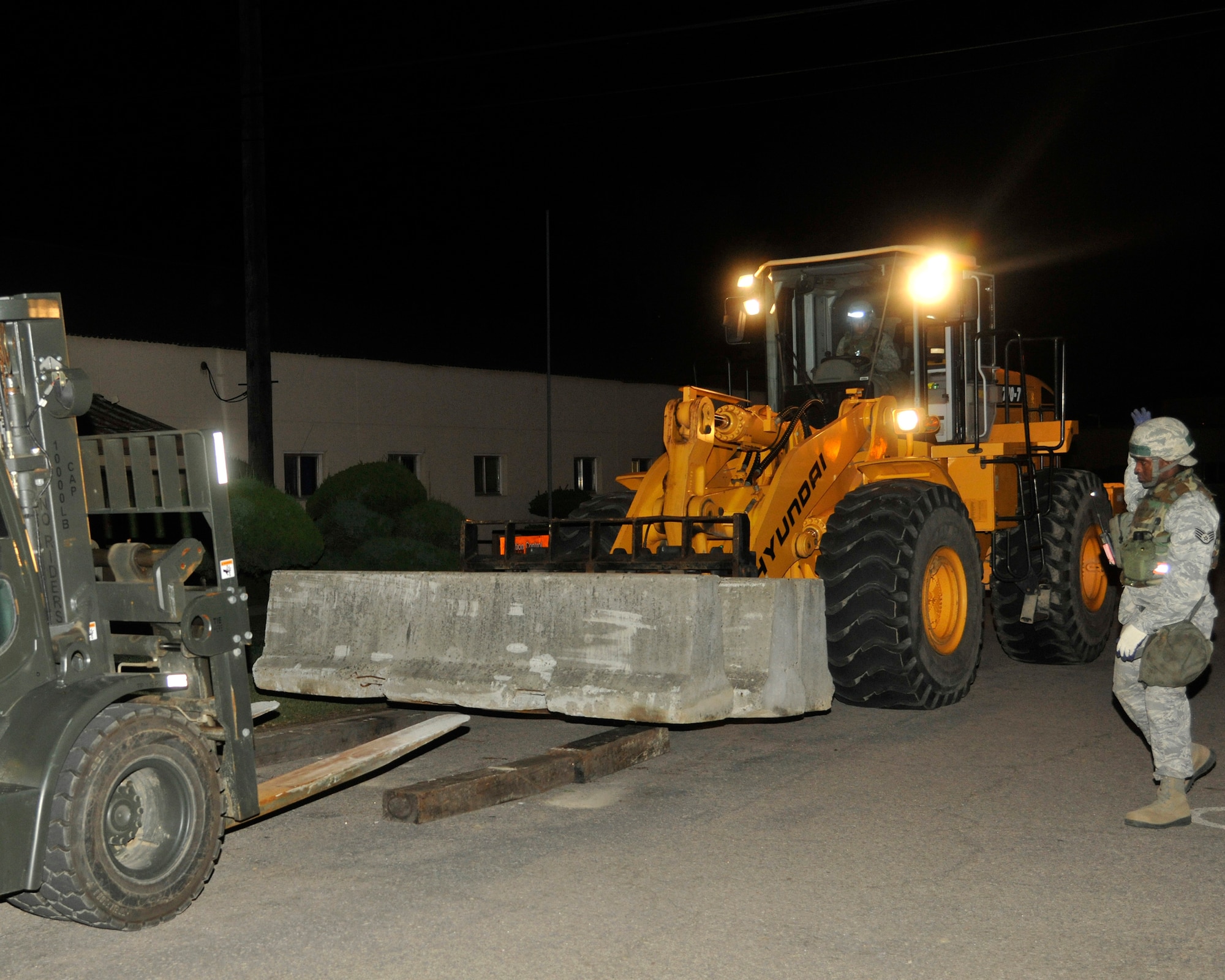 Staff Sgt. Mardie Wilson, 8th Civil Engineer Squadron heavy equipment and pavement operator, guides a forklift at Kunsan Air Base, Republic of Korea, July 8, 2012. The barricades limit traffic on base during the exercise. (US Air Force photo/Senior Airman Marcus Morris) 
