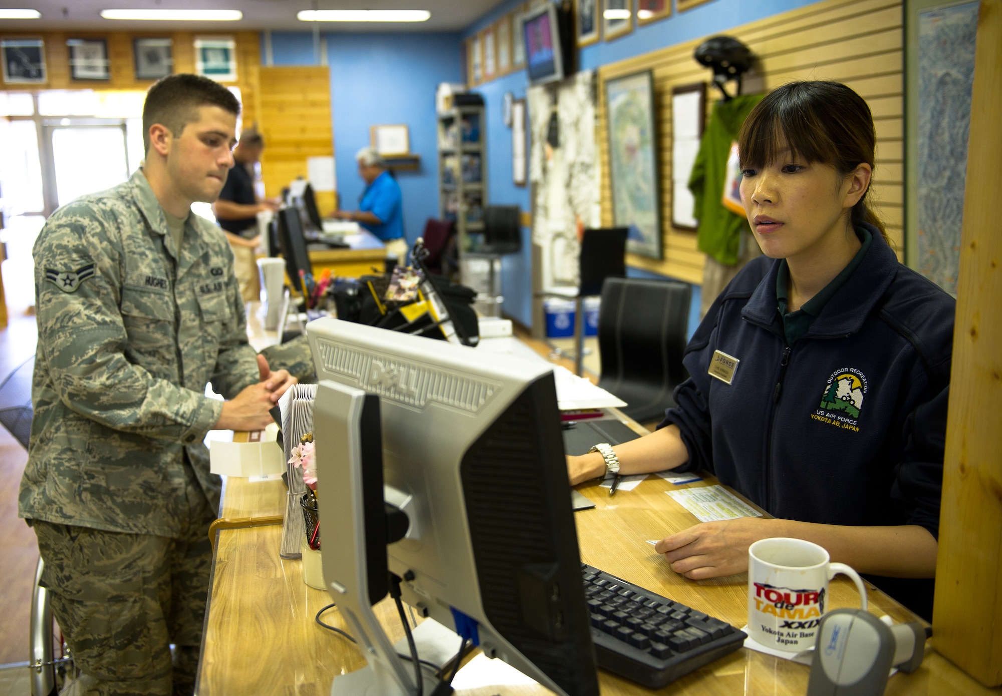 YOKOTA AIR BASE, Japan -- Chie Shimazu, Outdoor Recreation assistant, helps Airman 1st Class Colton Hughes, 374th Operations Support Squadron aircrew flight equipment specialist, July 10, 2012, at Yokota Air Base, Japan. The Outdoor Recreation center offers a variety of tours and trips as well as rental equipment. (U.S. Air Force photo by Staff Sgt. Chad C. Strohmeyer)