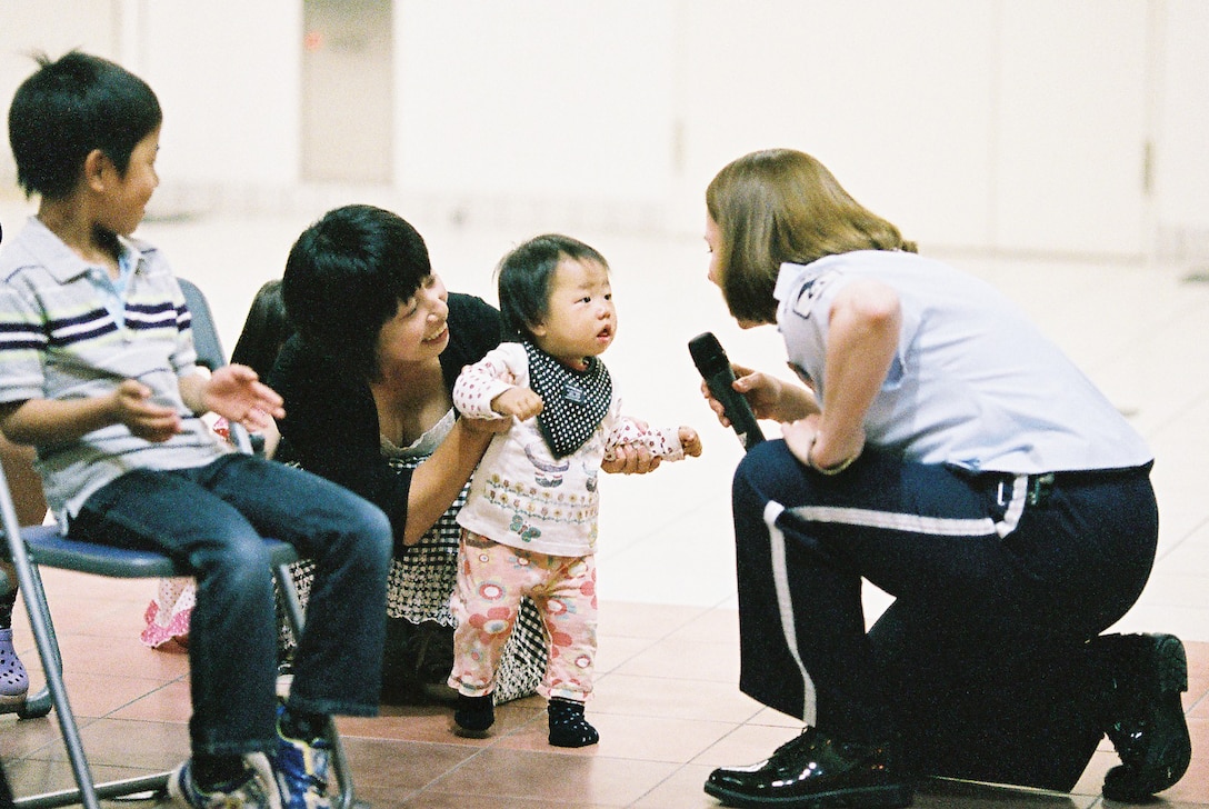 MUTSU CITY, Japan -- Master Sgt. Paula Goetz, Band of the Pacific-Asia vocalist, sings directly to a child at the Mutsu Kasamaeka Facility, Japan, June 4, 2012. Goetz made several trips into the audience to create a more personal experience for them. (U.S. Air Force photo/Staff Sgt. Josh Voyles)