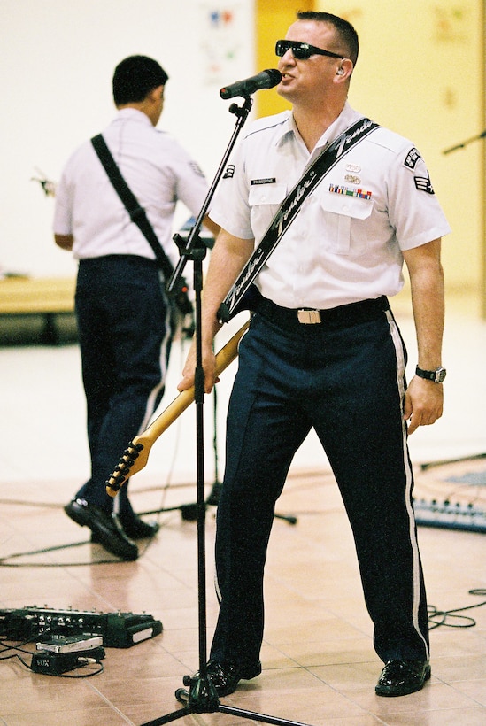 MUTSU CITY, Japan -- Senior Airman William Pressgrove, Band of the Pacific-Asia vocalist, wears sunglasses during ZZTop's "Sharp Dressed Man" at the Mutsu Kasamaeka Facility, Japan, June 4, 2012. Pressgrove regulary looked for ways to enhance his performance. (U.S. Air Force photo/ Staff Sgt. Josh Voyles)