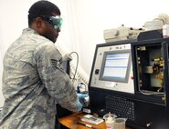 Senior Airman Terrance Kelley tests oil samples in a Spectroil M-unit, July 6, 2012, to find trace elements that signal the wear and tear of wear metals in an aircraft. The 51st Maintenance Squadron NDI Airmen use the Joint Oil Analysis Program to look for small trace elements that may cause serviceability issues later. Kelley is a NDI journeyman. (U.S. Air Force photo/Staff Sgt. Stefanie Torres)
