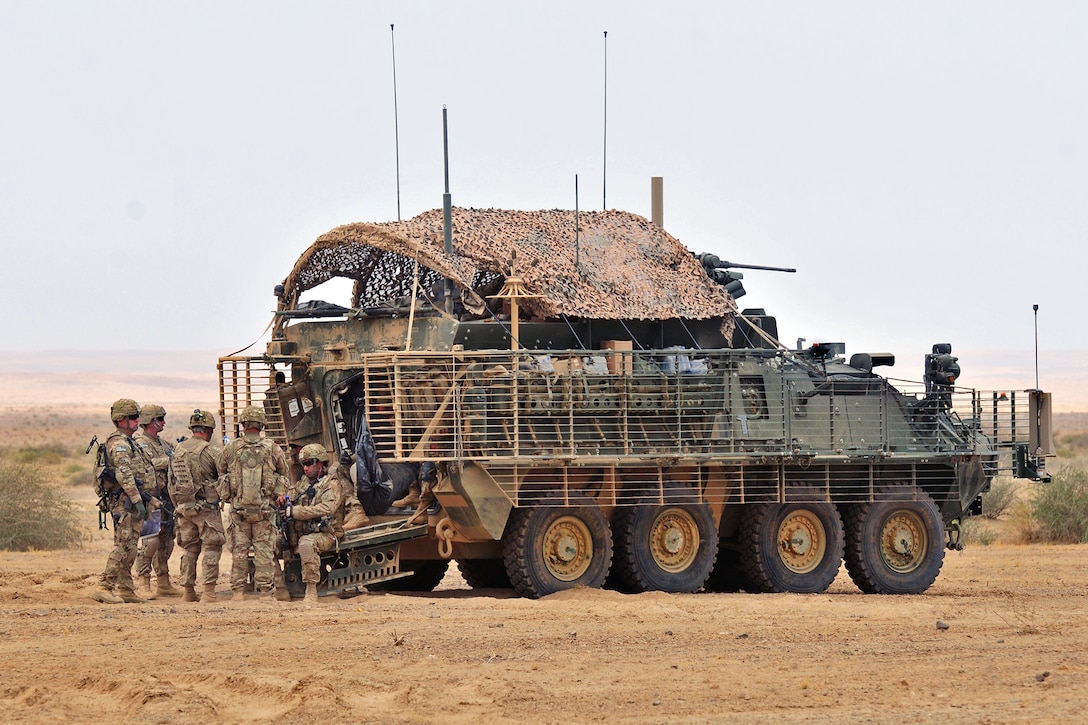 U.S. soldiers hold a meeting at their unit's tactical assembly area during Operation Buffalo Thunder II in the Shorabak district of Afghanistan's Kandahar province, June 28, 2012. The soldiers are assigned to the 2nd Infantry Division's Headquarters Company, 1st Battalion, 17th Infantry Regiment.