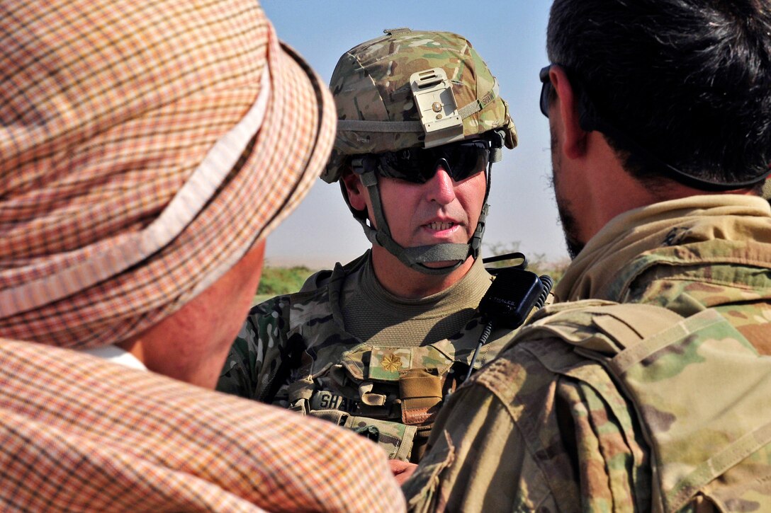 U.S. Army Maj. Roger Shaw listens to Afghan police at a checkpoint during Operation Buffalo Thunder II near Baradge Kotal in Afghanistan's Kandahar province, June 29, 2012. Shaw is assigned to the 2nd Infantry Division's 3rd Stryker Brigade Combat Team.