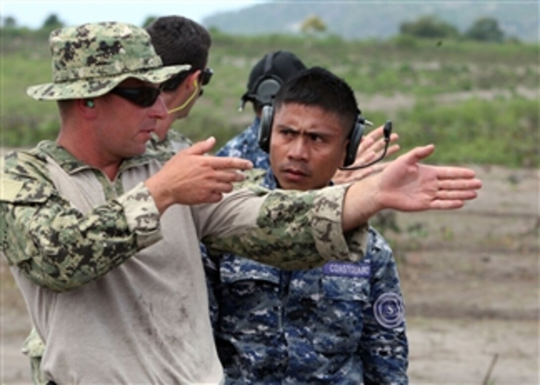 U.S. sailors and Filipino service members discuss firing stance techniques during Cooperation Afloat Readiness and Training 2012 in General Santos City, Philippines, on July 7, 2012.  Cooperation Afloat Readiness and Training is a series of bilateral exercises held annually in Southeast Asia to strengthen relationships and enhance force readiness.  