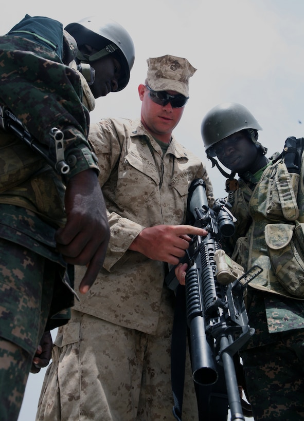 During some free time at the range for Exercise Western Accord 2012, Lance Cpl. Frederick P. Shearon, a rifleman from 3rd Battalion, 25th Marine Regiment and Columbus, Ohio, native, shows some Gambian soldiers the features of his weapon system, an M16 service rifle mounted with an M203 grenade launcher. Exercise Western Accord 2012 is a multi-lateral training exercise with West African nations to increase understanding and interoperability, prevent conflict by enabling Africans to provide for their security and stability, strengthen relationships with partner nations, and promote and support U.S. national security priorities. Participating African nations include Senegal, Burkina Faso, Guinea, and Gambia, who will be working with U.S. troops in Senegalese training sites until July 24.::r::::n::