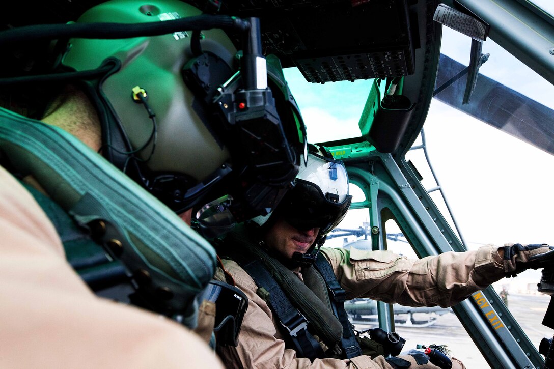 Capt. Jonathan A. Chunn (right), CH-53 pilot with Marine Heavy Helicopter Squadron 463, and Capt. Alex J. Runyan, UH-1Y pilot with Marine Light Attack Helicopter Squadron 169, conduct preflight checks before cross-cockpit training July 7, as part of Rim of the Pacific 2012. Multiple detachments of aviation and support units will be assigned to HMH 463 (reinforced) during RIMPAC 12 to comprise the aviation combat element of Special Purpose Marine Air-Ground Task Force 3. Approximately 2,200 personnel from nine nations comprise SPMAGTF-3, Combined Force Land Component Command. The CFLCC is conducting amphibious and land-based operations in order to enhance multinational and joint interoperability.