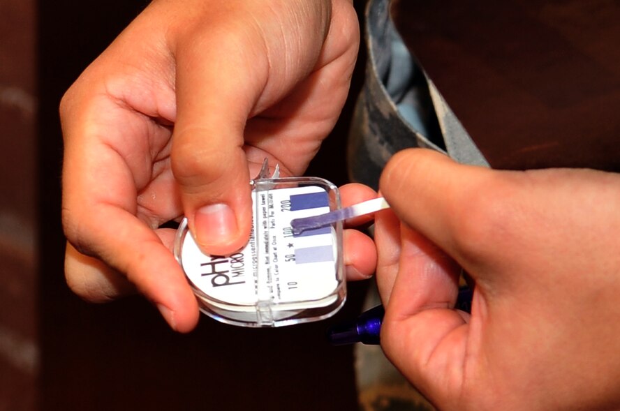 Senior Airman Rene Martinez, 51st Aerospace Medicine Squadron Public Health food inspector, conducts a pH test on a cleaning solution at Osan Air Base, Republic of Korea, July 11, 2012. The test determines whether the pH levels of cleaning water are in line with standards.  Only detergents deemed safe may be used to clean food service areas. (U.S. Air Force photo/Staff Sgt. Craig Cisek)