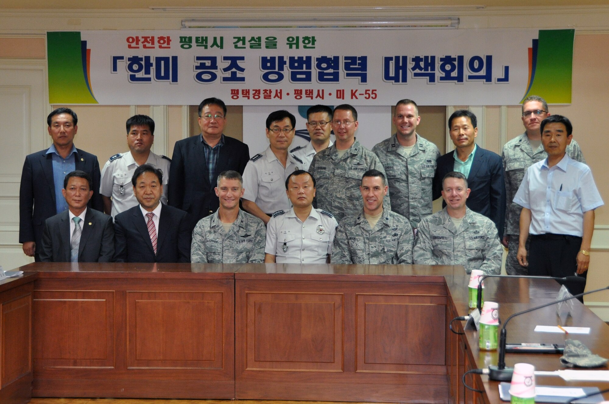 Airmen of the 51st Fighter Wing and city officials pose for a group photo following a Town Patrol Cooperation Meeting in Pyeongteak, Republic of Korea, July 10, 2012. The commanders and city officials discussed joint town patrols, Korean Nation Police assistance with parking restrictions, the off-limits establishments to U.S. Forces Korea personnel and expanding the Osan and Songtan Community Advisory Council. (U.S. Air Force photo)