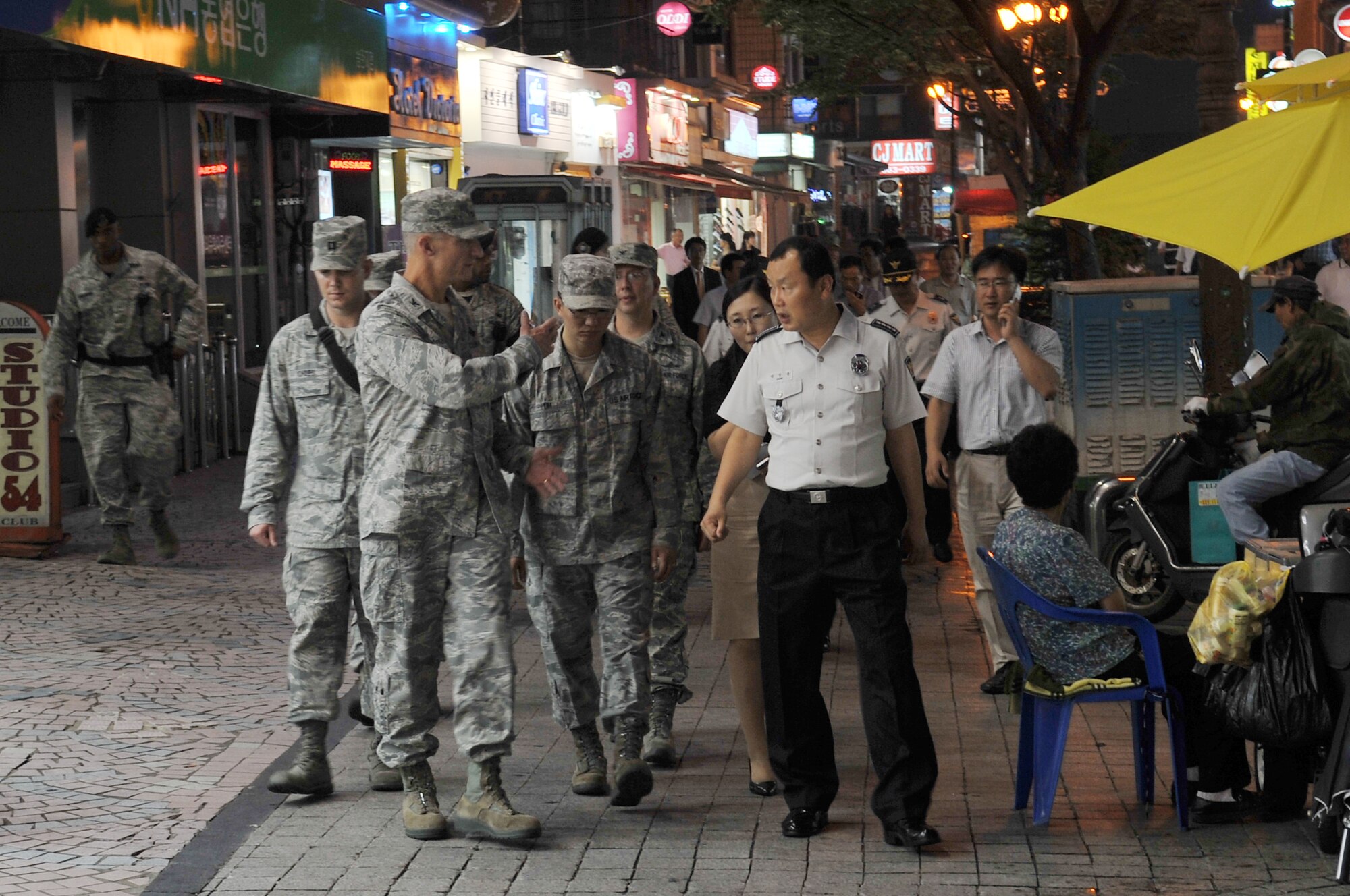 Col. Patrick McKenzie, 51st Fighter Wing commander, Mr. Sang Yung Pak, Chief of Pyeongtaek Police, lead a contingent of several city council members July 10, 2012, on a joint town patrol in the Songtan Entertainment District, just outside the gates of Osan Air Base, Republic of Korea. The patrol is part of an effort to strengthen the alliance between the ROK and United States, and it highlights the importance of joint partnership in law enforcement and force protection. The commanders also discussed joint town patrols, Korean Nation Police assistance with parking restrictions, and off-limits establishments to U.S. Forces Korea personnel. (U.S. Air Force photo/Staff Sgt. Craig Cisek)